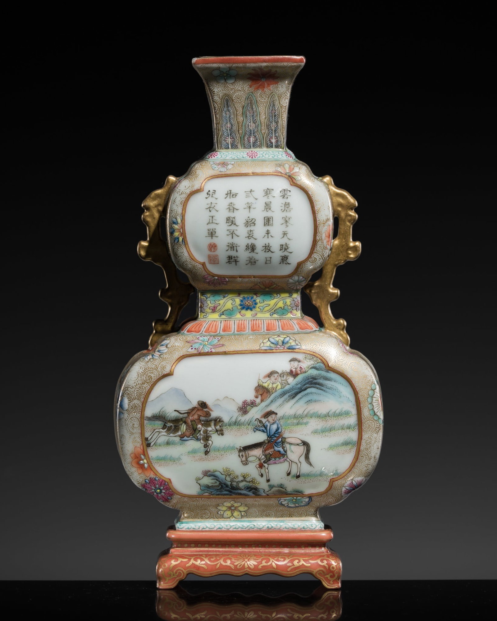 A GILT FAMILLE ROSE DOUBLE GOURD WALL VASE WITH HUNTING SCENE AND A POEM BY THE QIANLONG EMPEROR,: † A GILT FAMILLE ROSE DOUBLE GOURD WALL VASE WITH HUNTING SCENE AND A POEM BY THE QIANLONG EMPEROR, LATE QING DYNASTY China, 1850-1912. The lower section with a central quatrefoil cartouche encl