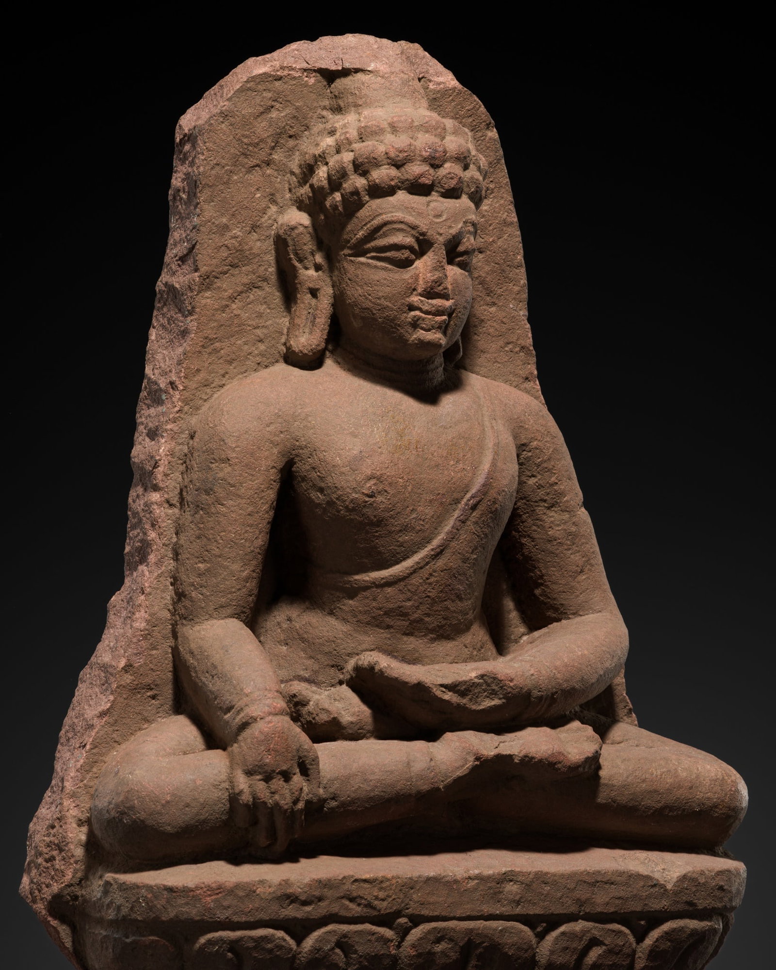 A RARE RED SANDSTONE STELE OF A SEATED JINA, GUPTA PERIOD, 4TH-5TH CENTURY (1 of 16)
