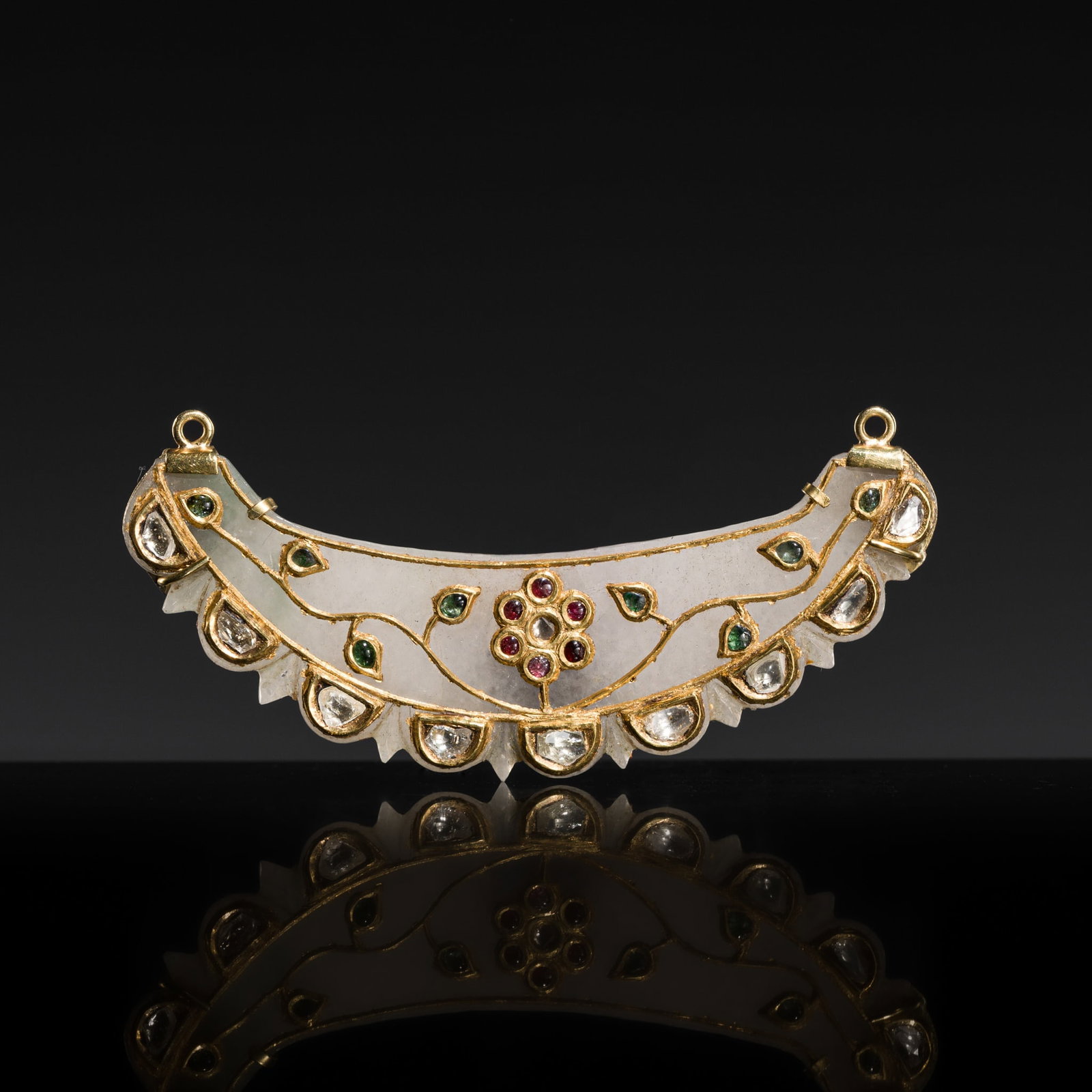 A MUGHAL GOLD-INLAID GEM-SET WHITE JADE PENDANT, 18TH-19TH CENTURY: A MUGHAL GOLD-INLAID GEM-SET WHITE JADE PENDANT, 18TH-19TH CENTURY Northern India. Finely carved in the form of a crescent moon, one side with a serrated profile, magnificently inlaid with gold and va