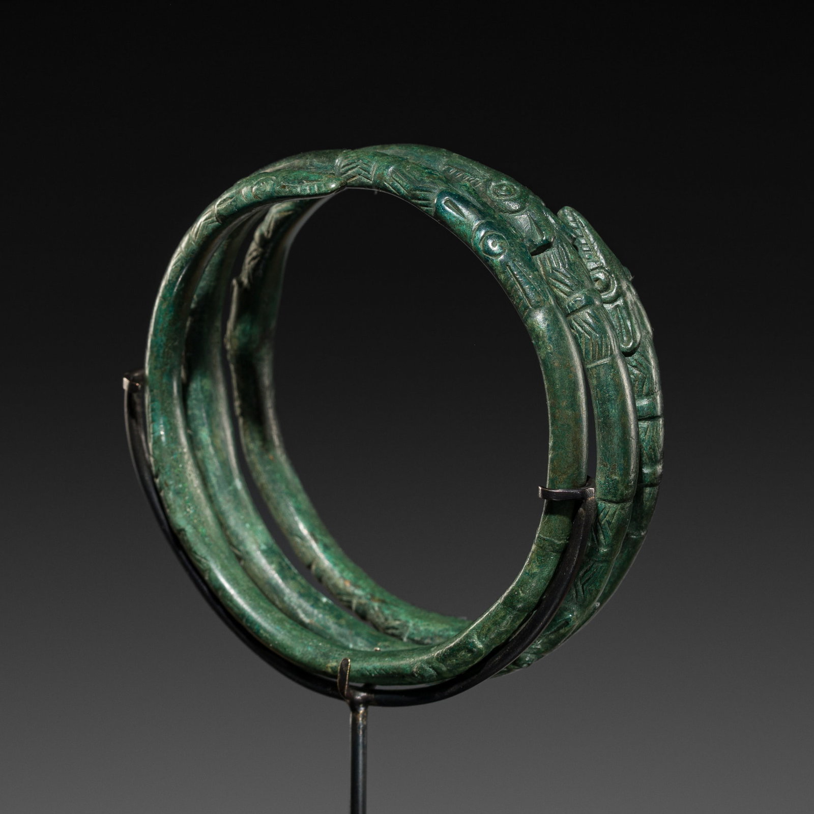 A RARE BRONZE BRACELET, SCYTHIAN CULTURE, EURASIAN STEPPE, CIRCA 500 BC: A RARE BRONZE BRACELET, SCYTHIAN CULTURE, EURASIAN STEPPE, CIRCA 500 BC Of multi-coiled, circular form, the band terminates in pointed animal heads, with further eight heads in between. Their snouts a