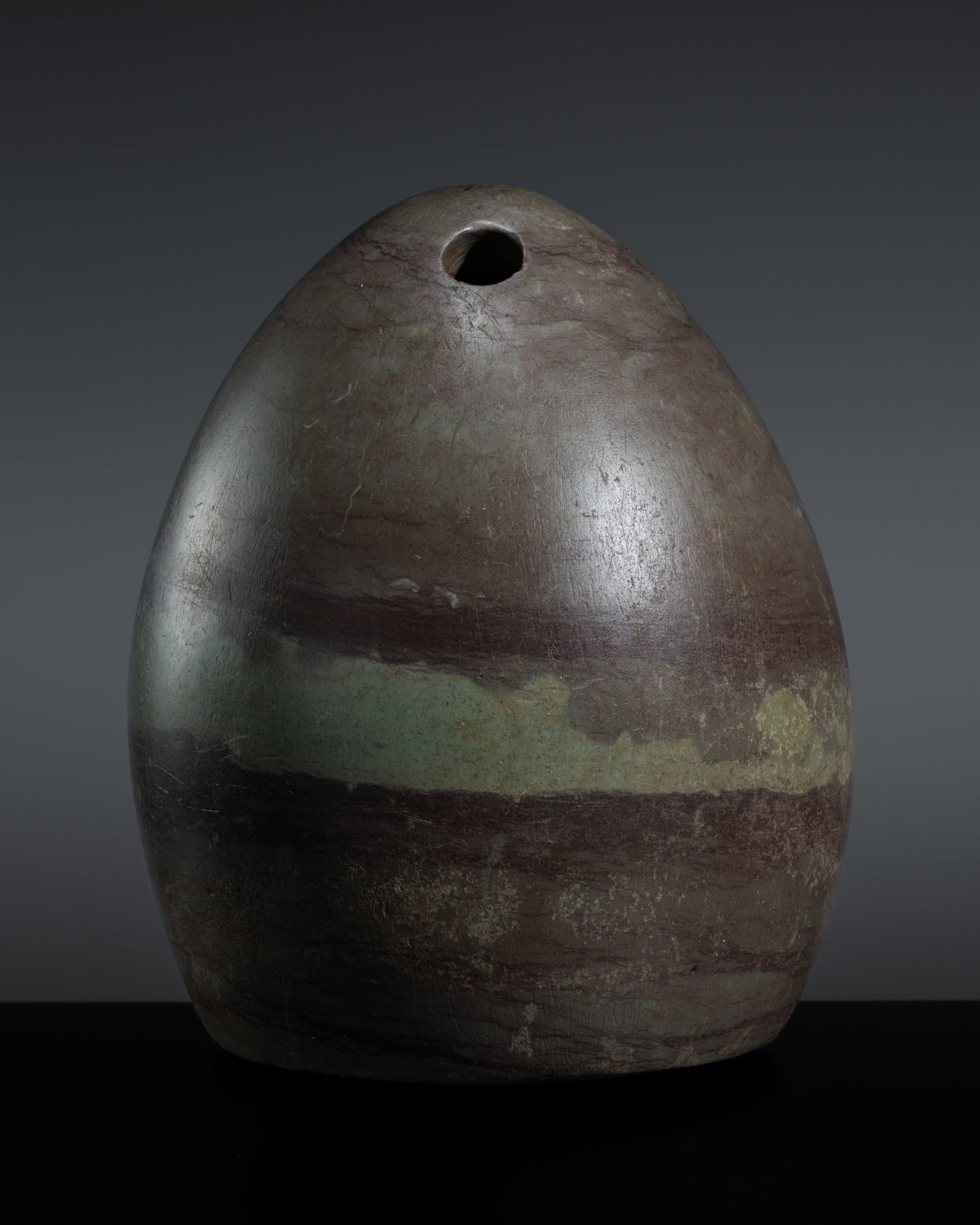 A BACTRIAN STONE WEIGHT, 3RD-2ND MILLENNIUM BC: A BACTRIAN STONE WEIGHT, 3RD-2ND MILLENNIUM BC Oxus Civilization. Of high domed form, supported on a flattened base and perforated at the apex for suspension, the apertures slightly converging in a V-
