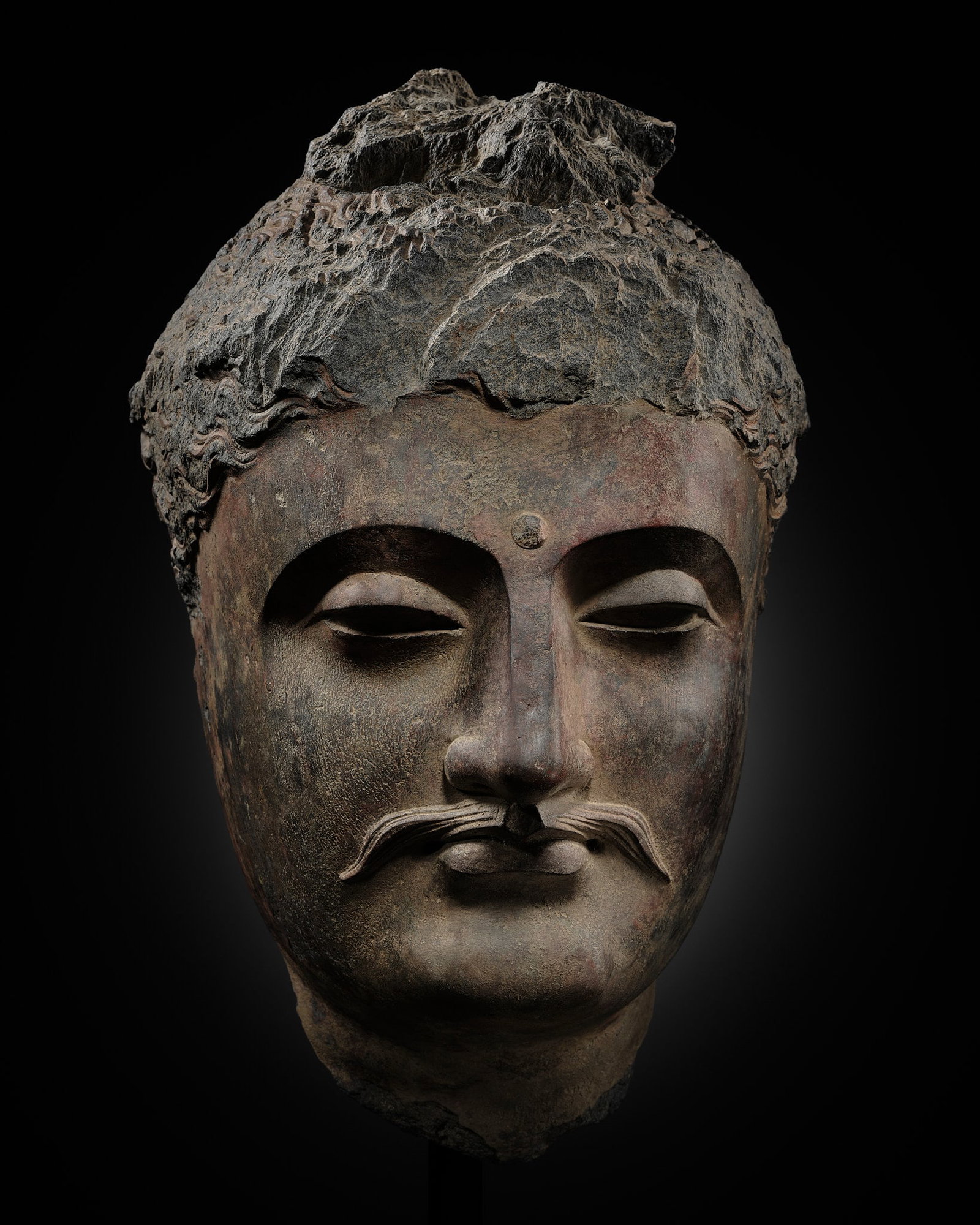 A LARGE GRAY SCHIST HEAD OF BUDDHA SHAKYAMUNI, ANCIENT REGION OF GANDHARA, 1ST-4TH CENTURY: A LARGE GRAY SCHIST HEAD OF BUDDHA SHAKYAMUNI, ANCIENT REGION OF GANDHARA, 1ST-4TH CENTURY Expert's note: This head was once part of a monumental frieze, from which it was removed a long time ago. It 