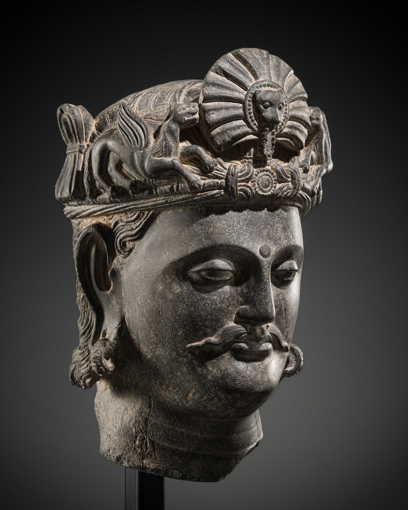 A SUPERB GRAY SCHIST HEAD OF A BODHISATTVA WITH A 'KIRTIMUKHA' TURBAN CREST, ANCIENT REGION OF (1 of 17)