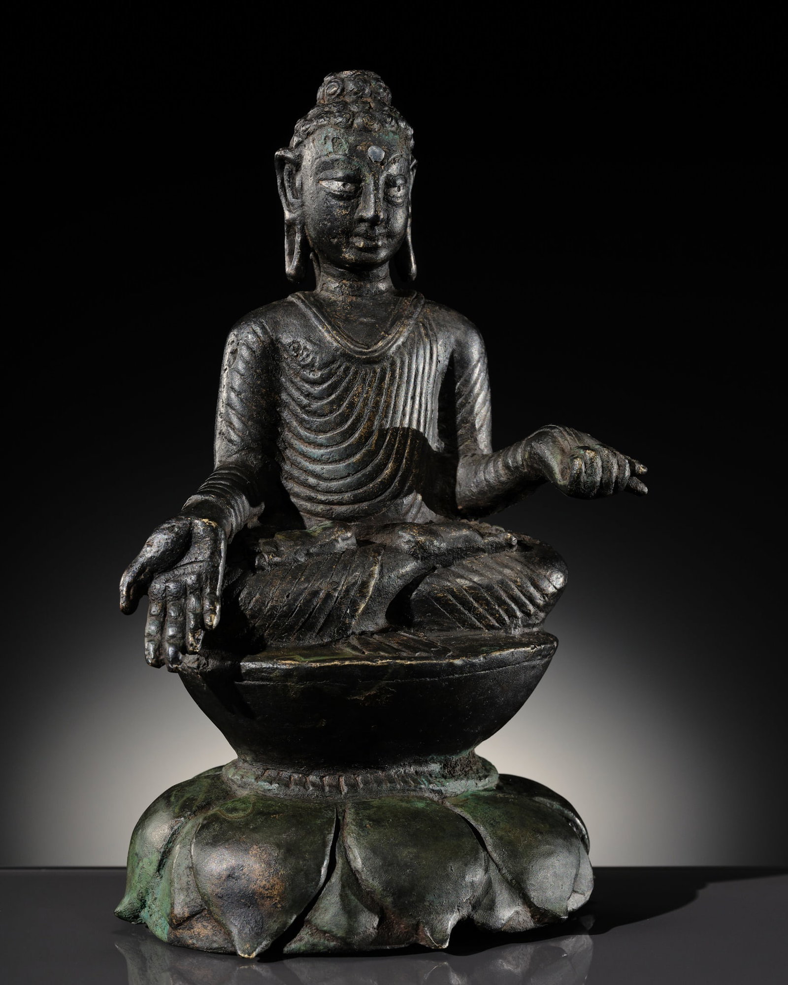 A COPPER-ALLOY FIGURE OF BUDDHA SHAKYAMUNI WITH SILVER-INLAID EYES, SWAT VALLEY, 7TH-8TH CENTURY (1 of 13)
