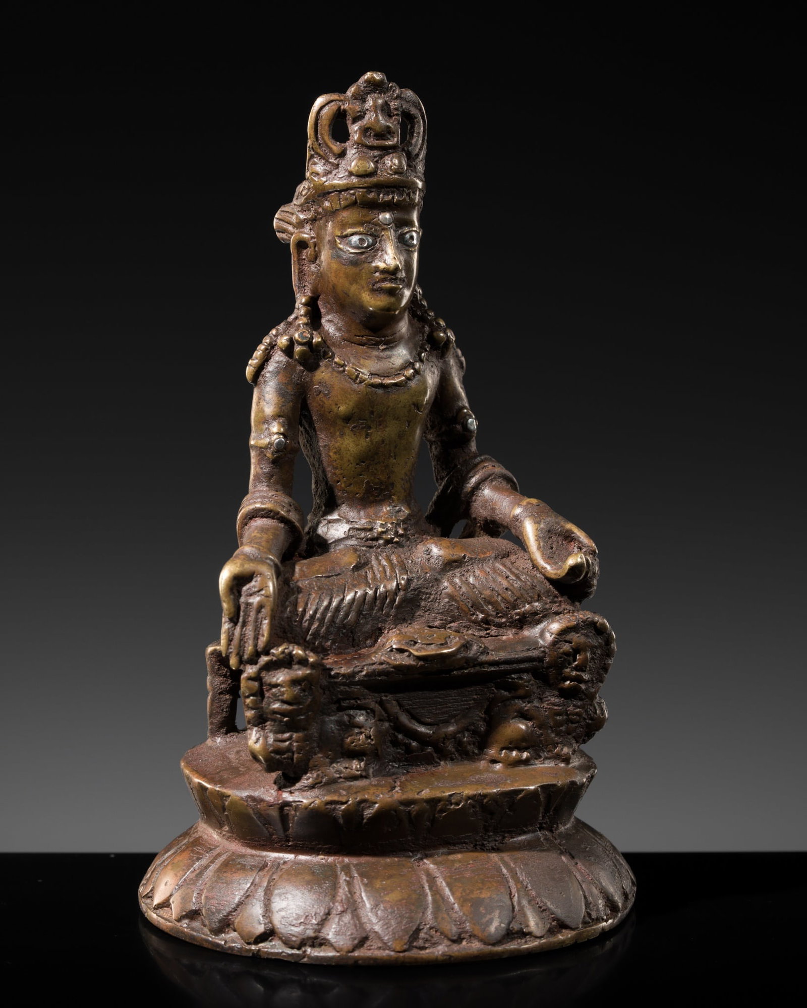A SILVER-INLAID BRONZE FIGURE OF MAITREYA ON A LION THRONE, KASHMIR: A SILVER-INLAID BRONZE FIGURE OF MAITREYA ON A LION THRONE, KASHMIR In the style of the Swat Valley of the 8th-9th century. Finely cast, seated in dhyanasana atop an elaborate pedestal supported by li