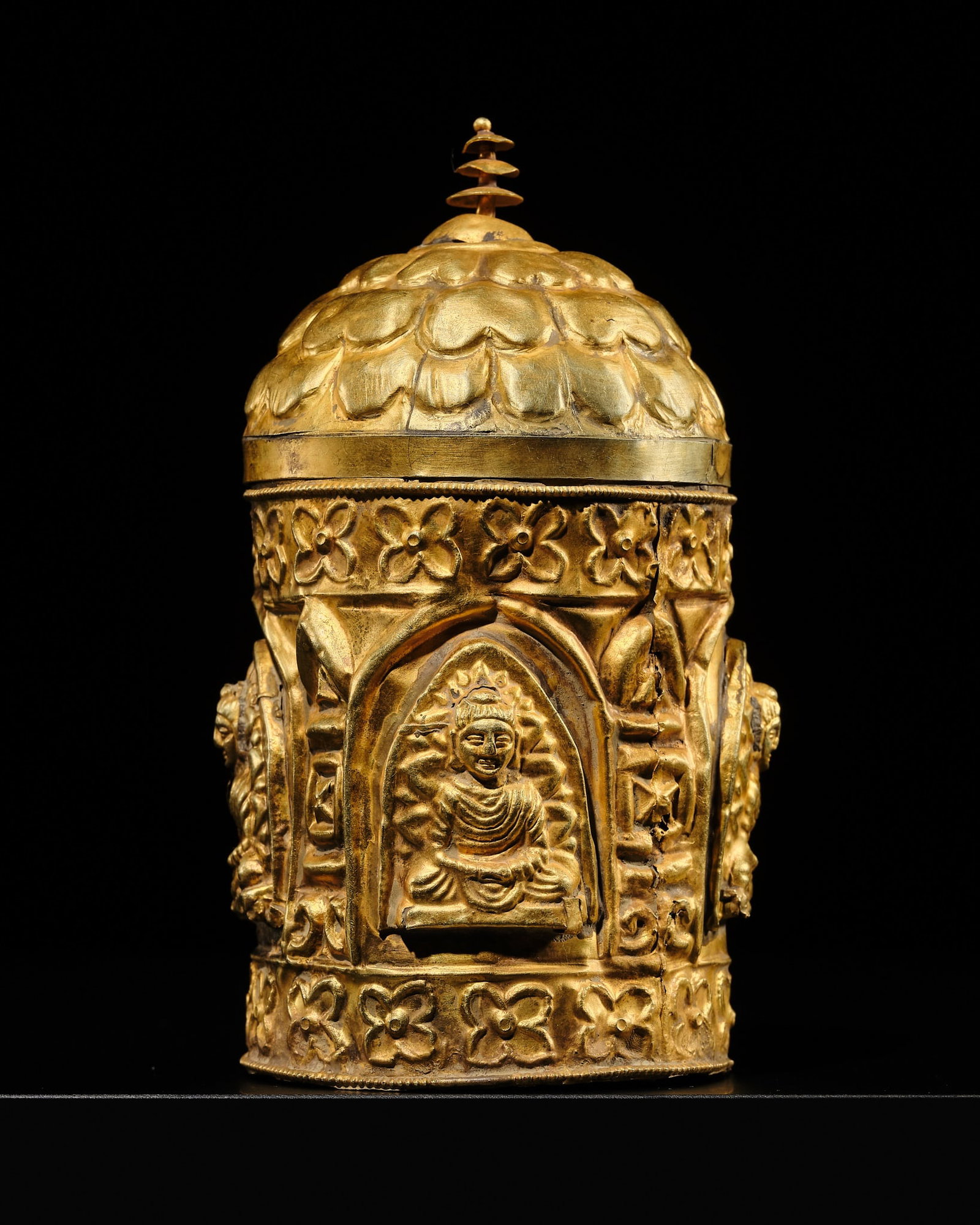 A VERY RARE 17K GOLD REPOUSSÉ 'FOUR BUDDHAS' RELIQUARY STUPA, ANCIENT REGION OF GANDHARA: † A VERY RARE 17K GOLD REPOUSSÉ 'FOUR BUDDHAS' RELIQUARY STUPA, ANCIENT REGION OF GANDHARA Kushan Empire, 1st-5th century AD. Superbly worked, the cylindrical body richly decorated with a