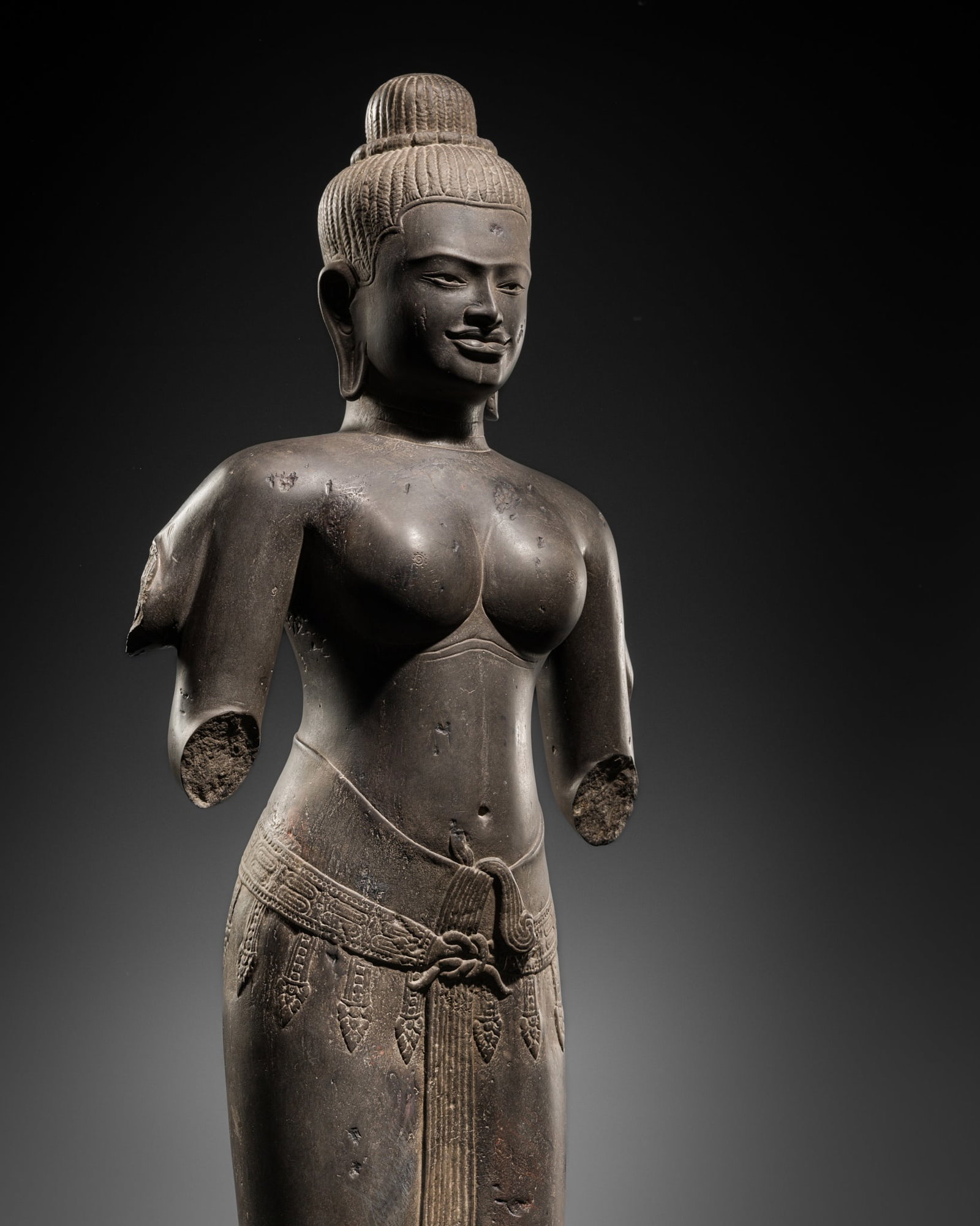 A RARE AND IMPORTANT SANDSTONE FIGURE OF UMA, ANGKOR PERIOD, 10TH-12TH CENTURY (1 of 12)