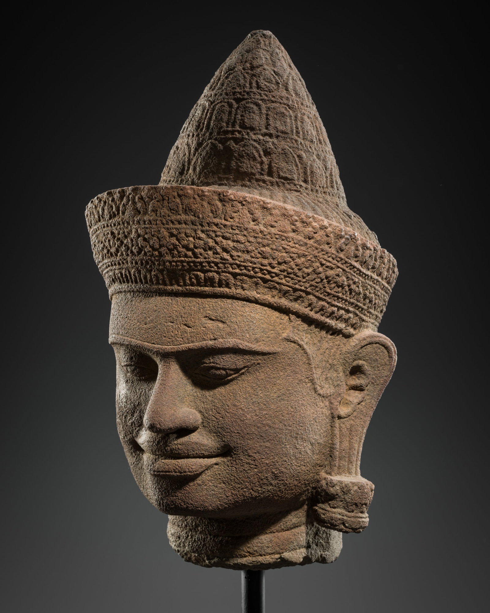 A SANDSTONE HEAD OF A MALE DEITY, ANGKOR WAT STYLE, 12TH CENTURY (1 of 10)