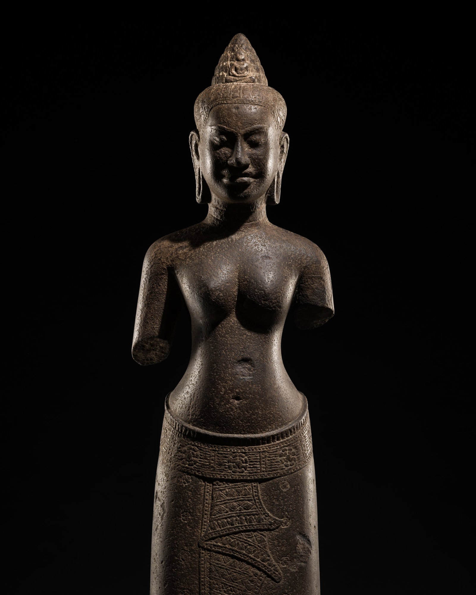 A SANDSTONE FIGURE OF A FEMALE DEITY, ANGKOR PERIOD, BAYON STYLE, LATE 12TH-EARLY 13TH CENTURY (1 of 14)