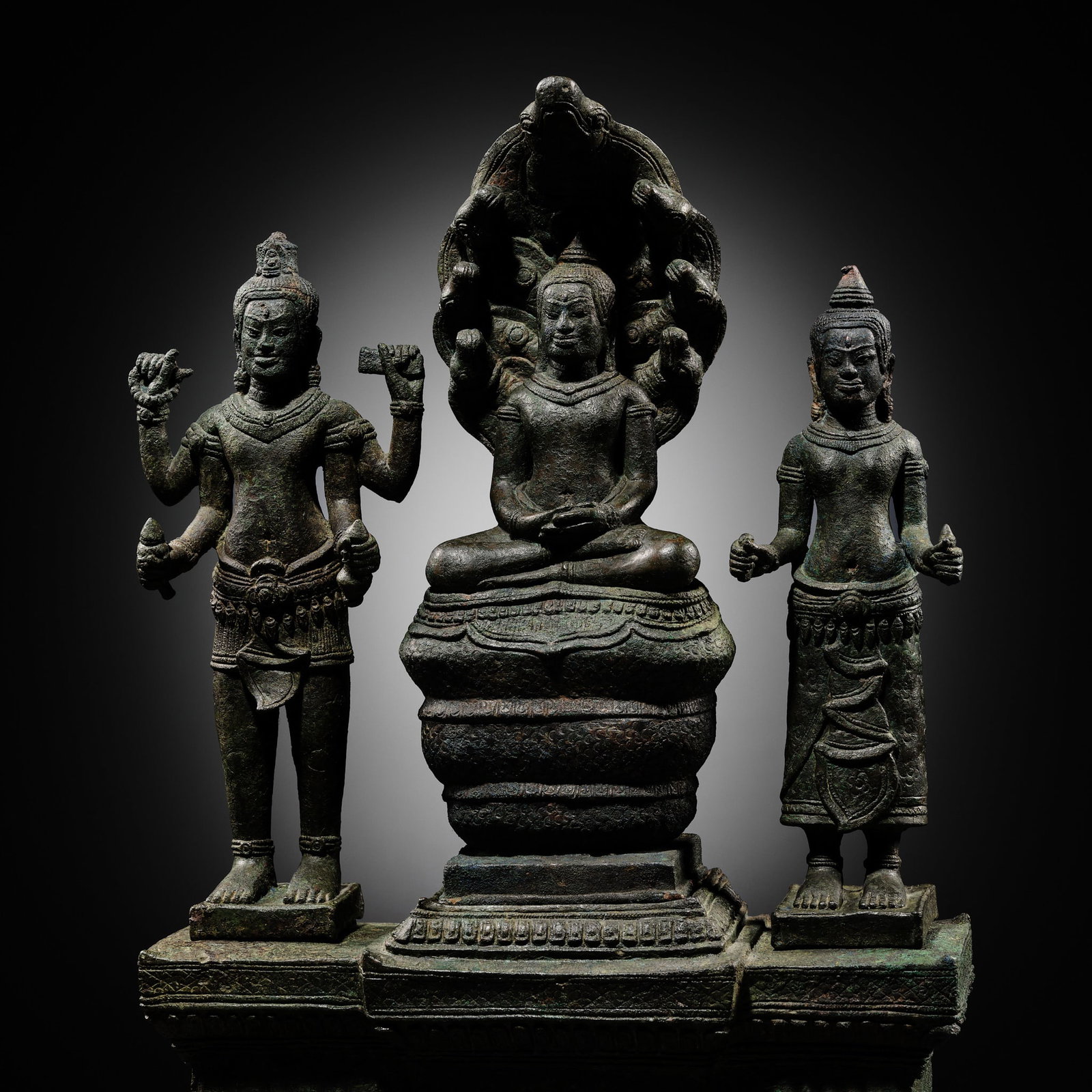 A BUDDHIST BRONZE TRIAD OF BUDDHA MUCHALINDA WITH HIS CONSORTS LOKESHVARA AND PRAJNAPARAMITA, BAYON (1 of 17)