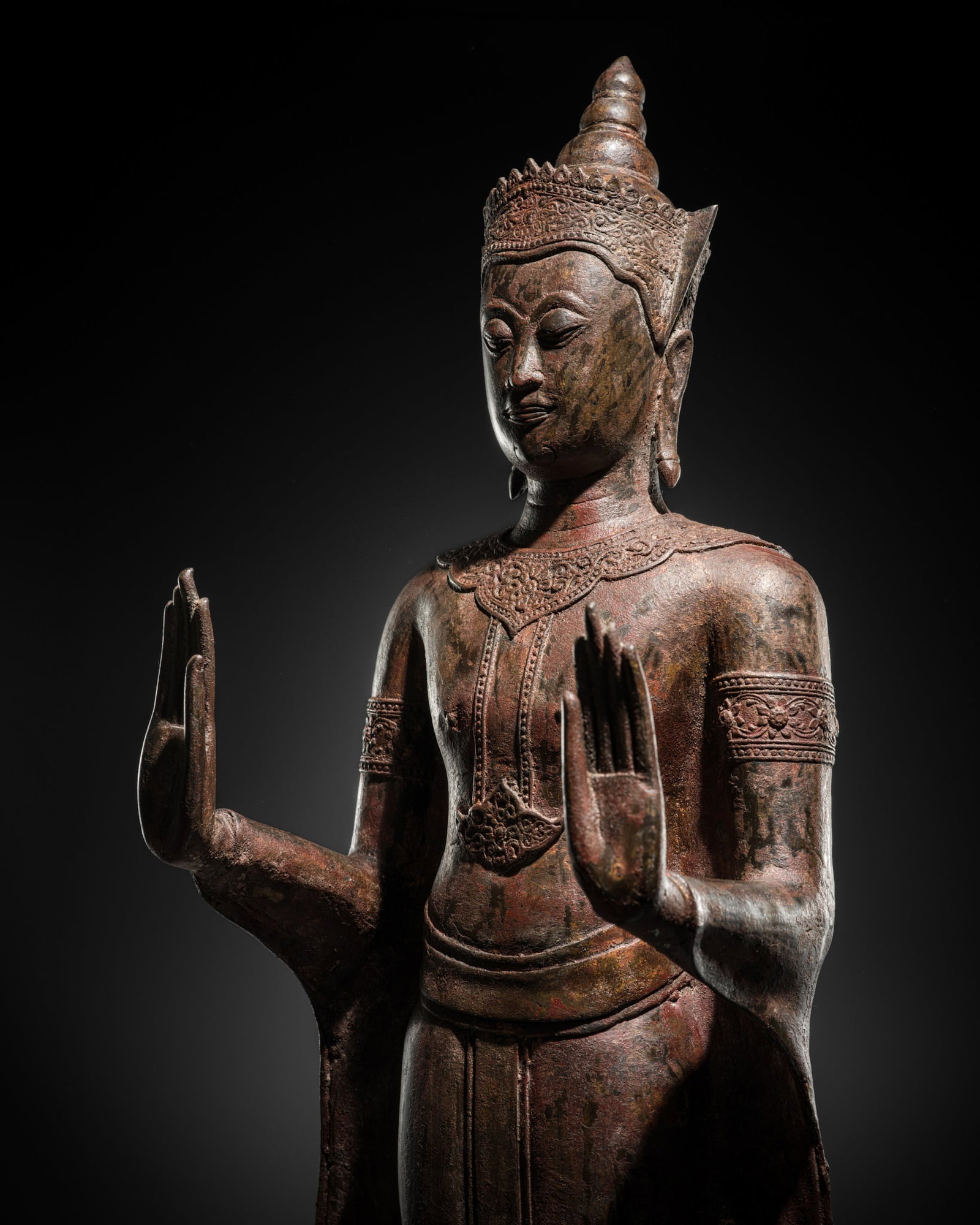 A BRONZE FIGURE OF A CROWNED BUDDHA, PHRA CHAO SONG KHRUANG ('A LORD WEARING ORNAMENTS'), AYUTTHAYA: A BRONZE FIGURE OF A CROWNED BUDDHA, PHRA CHAO SONG KHRUANG ('A LORD WEARING ORNAMENTS'), AYUTTHAYA PERIOD, 17TH CENTURY Thailand. Standing in samabhanga with both hands thrust forward in abhaya mudra