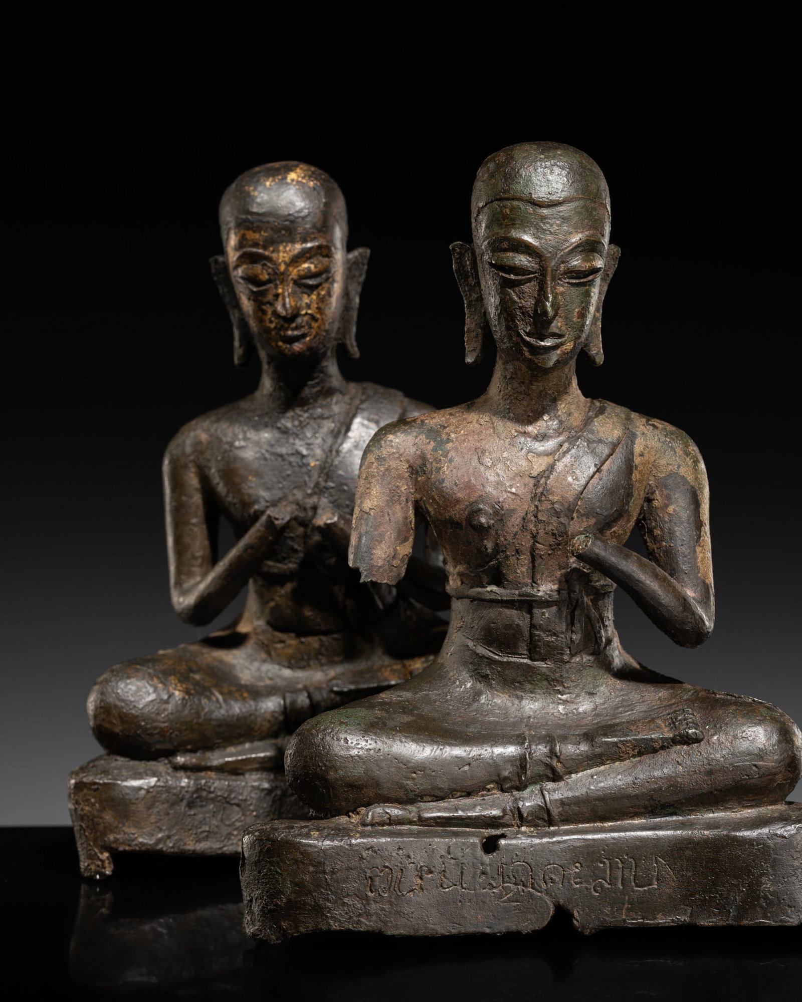 A PAIR OF BRONZE FIGURES OF SARIPUTRA AND MAUDGALYAYANA, AYUTTHAYA PERIOD: A PAIR OF BRONZE FIGURES OF SARIPUTRA AND MAUDGALYAYANA, AYUTTHAYA PERIOD Expert's note: This pair of disciples was once part of a larger group centered of course by a figure of Buddha, typically disp