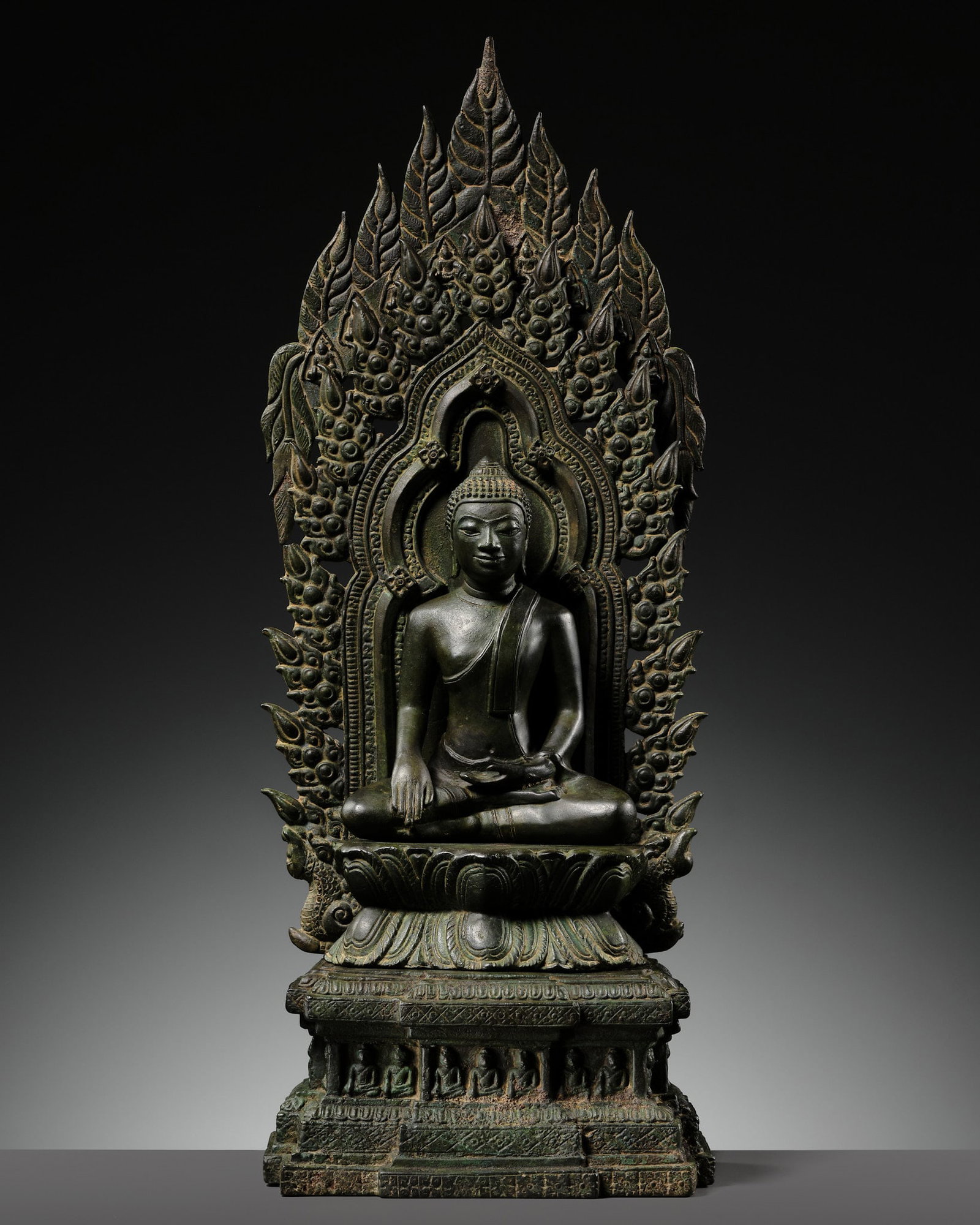 A BRONZE SHRINE OF BUDDHA, THAILAND, LOPBURI STYLE: † A BRONZE SHRINE OF BUDDHA, THAILAND, LOPBURI STYLE Thailand, circa 18th-19th century or earlier. Cast in several pieces, the Buddha depicted seated in ardhapadmasana on a double-lotus pedestal