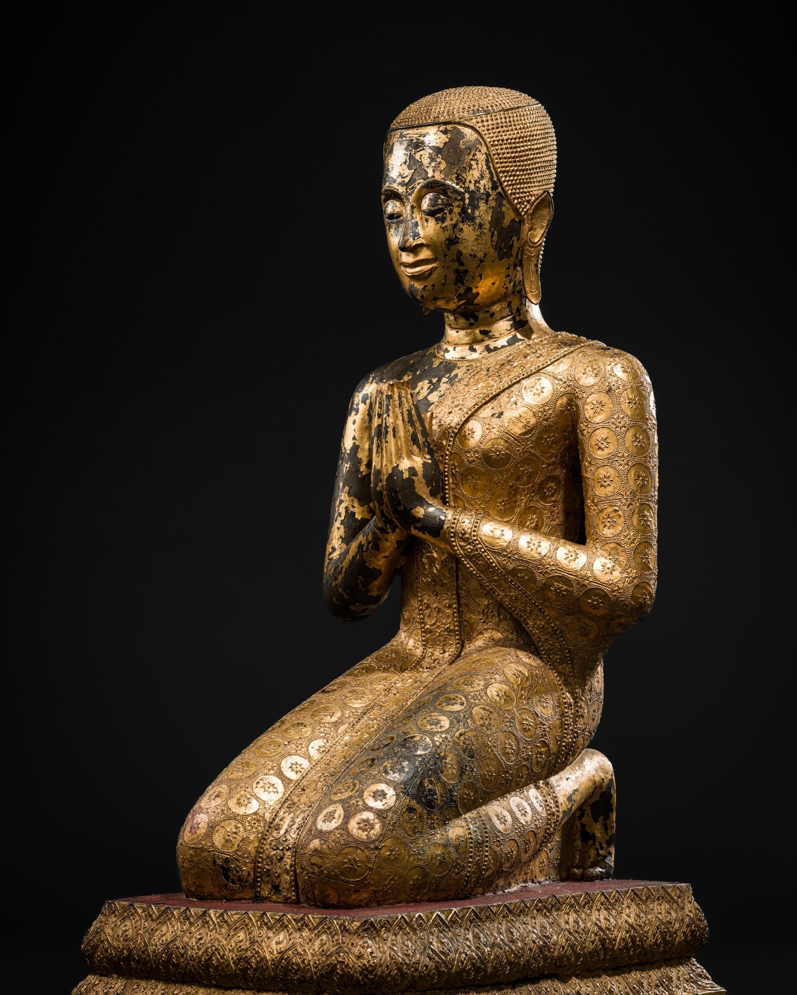 A LARGE GILT-LACQUERED BRONZE FIGURE OF A MONK, RATTANAKOSIN KINGDOM: A LARGE GILT-LACQUERED BRONZE FIGURE OF A MONK, RATTANAKOSIN KINGDOM Thailand, reign of King Rama III, 1824-1851. Finely cast, the disciple kneeling on a rectangular, tiered base with his hands held i