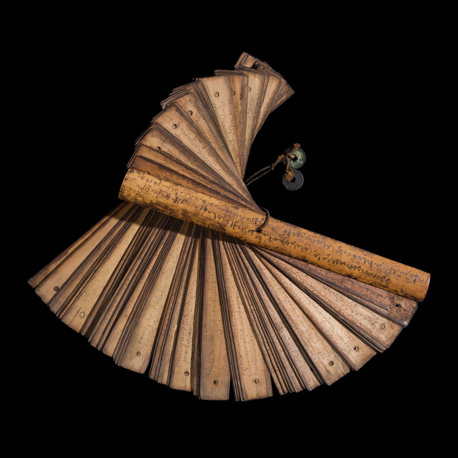 A TAI BUDDHIST PALM-LEAF MANUSCRIPT BOUND BETWEEN TWO INSCRIBED WOODEN BOARDS (1 of 11)