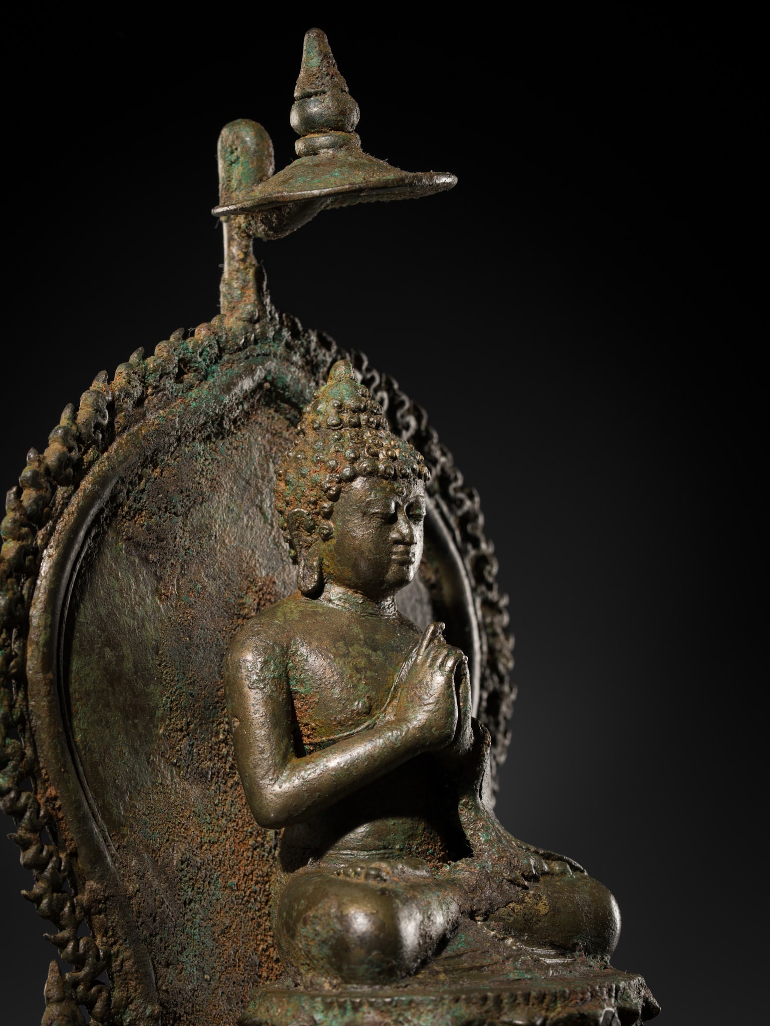 AN IMPORTANT BRONZE FIGURE OF THE COSMIC BUDDHA VAIROCANA, CENTRAL JAVA, 8TH-9TH CENTURY: AN IMPORTANT BRONZE FIGURE OF THE COSMIC BUDDHA VAIROCANA, CENTRAL JAVA, 8TH-9TH CENTURY Seated in dhyanasana on a double-lotus base over a raised tiered plinth, the hands held to the chest in the ges