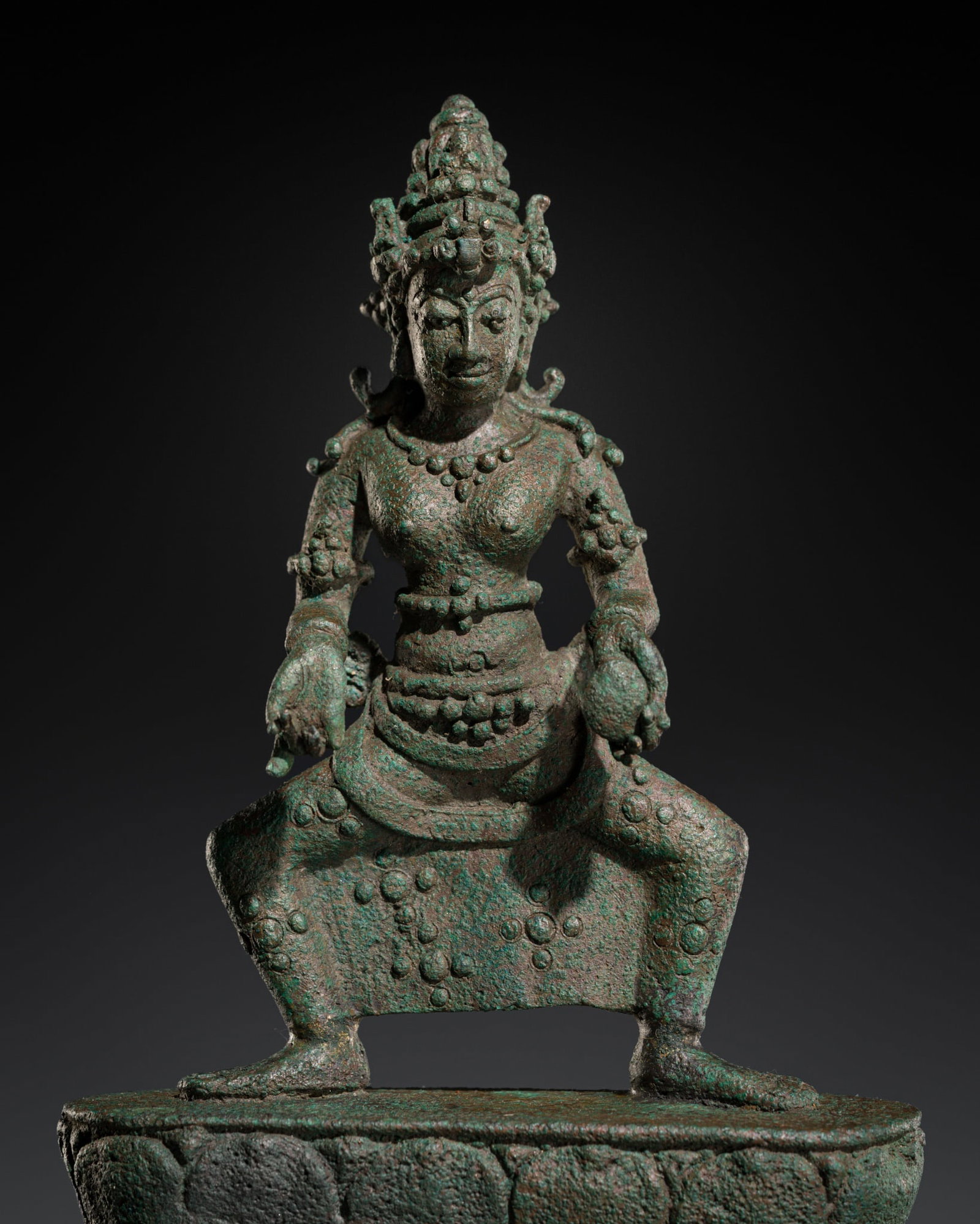 A RARE BRONZE FIGURE OF A RAKSHASI, CENTRAL JAVA, 9TH-10TH CENTURY: A RARE BRONZE FIGURE OF A RAKSHASI, CENTRAL JAVA, 9TH-10TH CENTURY Indonesia. Standing in a wide, squatting stance on a lotus dais atop a tiered base, the right hand held in shuni mudra and the left h