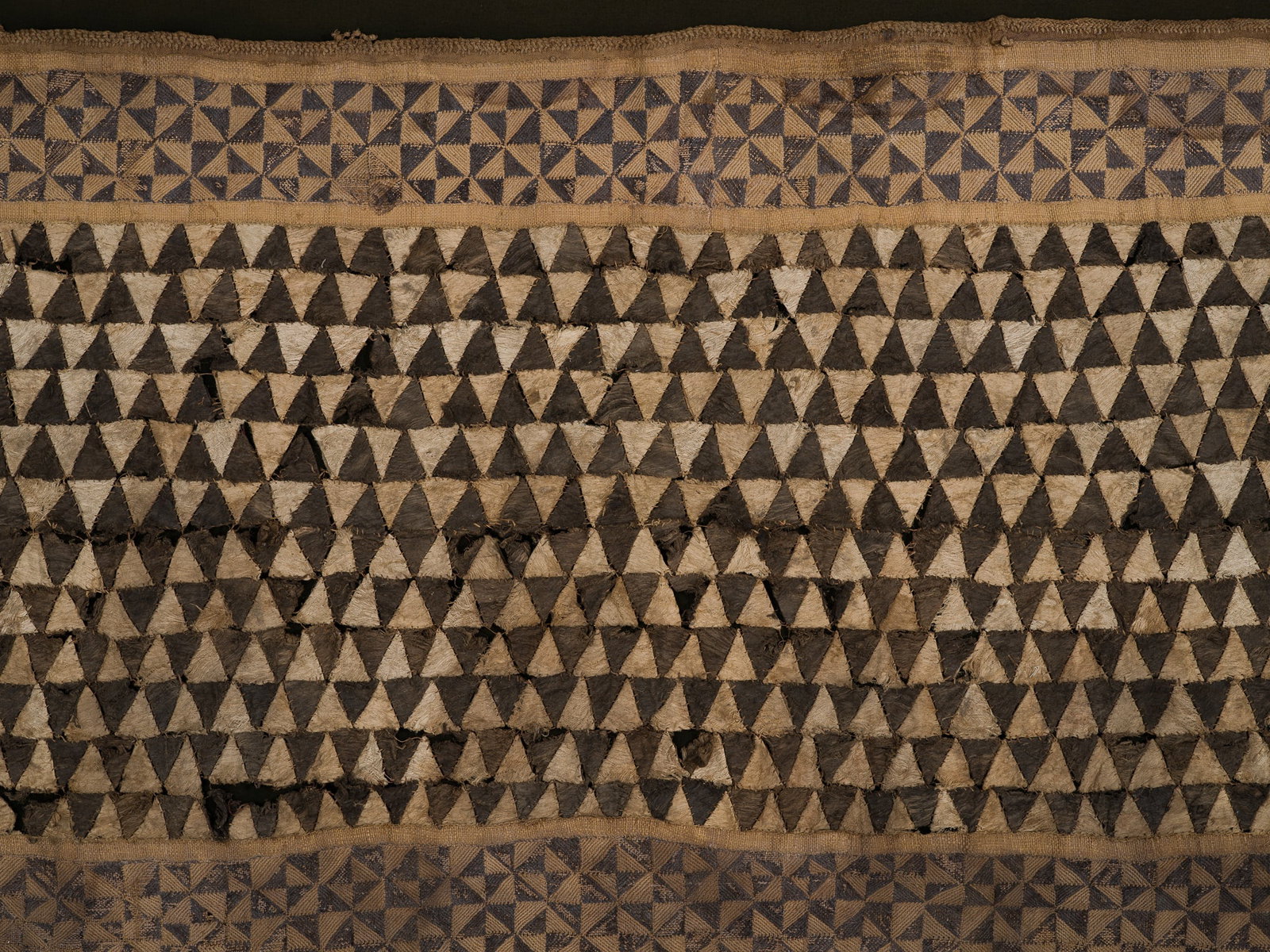 A KUBA WOVEN RAFFIA AND EMBROIDERED TEXTILE CEREMONIAL OVERSKIRT, NTSHAK, LATE 19TH-EARLY 20TH (1 of 12)