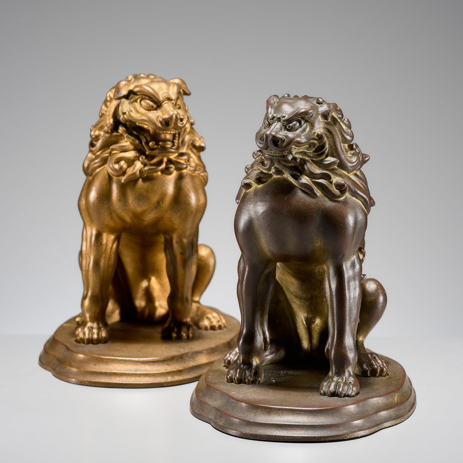 KATORI HOTSUMA: A PAIR OF POWERFUL BRONZE SHISHI: KATORI HOTSUMA: A PAIR OF POWERFUL BRONZE SHISHI By Katori Hotsuma (1874-1954), signed Katori saku Japan, c. 1935-1940, Showa period (1926-1989) Each seated on its haunches atop a lobed base, the fero