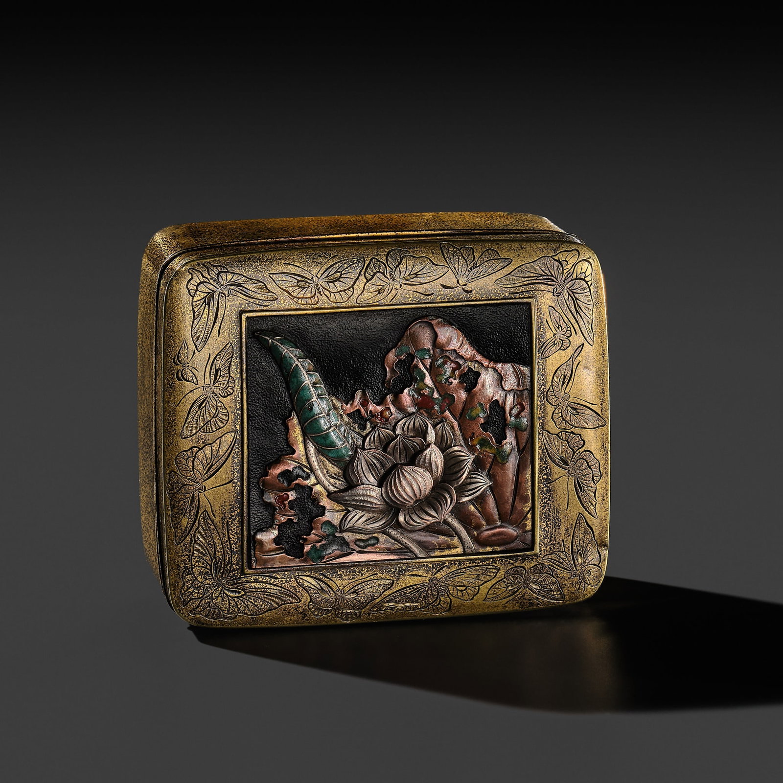 SHINBO: A FINE MIXED METAL AND ENAMEL INLAID GILT BRONZE ‘LOTUS’ BOX AND COVER: SHINBO: A FINE MIXED METAL AND ENAMEL INLAID GILT BRONZE ‘LOTUS’ BOX AND COVER By Shinbo, sealed Shinbo Japan, Meiji period (1868-1912) Of rectangular form, the inrobuta (flush-fitting) li