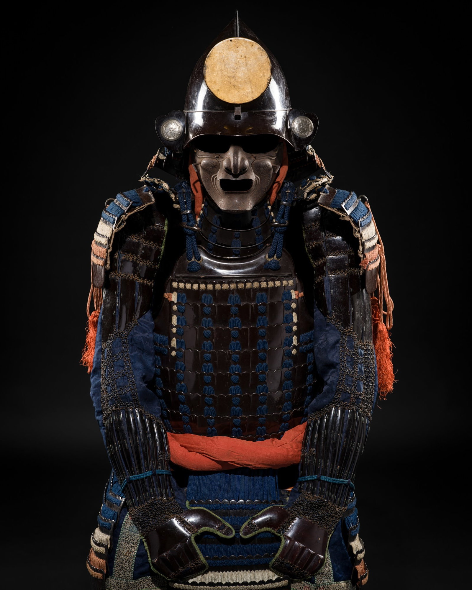 † AN OKEGAWA NIMAI-DO GUSOKU (TWO-PIECE CUIRASS ARMOR) AND AN IRON MOMONARI KABUTO: † AN OKEGAWA NIMAI-DO GUSOKU (TWO-PIECE CUIRASS ARMOR) AND AN IRON MOMONARI KABUTO Japan, 17th-18th century, Edo period (1615-1868) The lacquered-iron components predominantly laced in blu