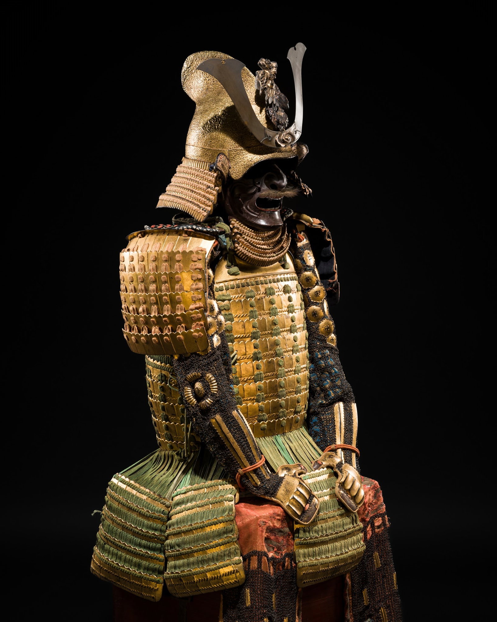 AN IMPRESSIVE GILT-LACQUERED NIMAI OKEGAWA DO GUSOKU (TWO-PIECE CUIRASS ARMOR) WITH A GOLD-LACQUERED: AN IMPRESSIVE GILT-LACQUERED NIMAI OKEGAWA DO GUSOKU (TWO-PIECE CUIRASS ARMOR) WITH A GOLD-LACQUERED IRON EBOSHI KABUTO AND RESSEI MENPO Japan, 17th-18th century, Edo period (1615-1868) The gold-lacqu