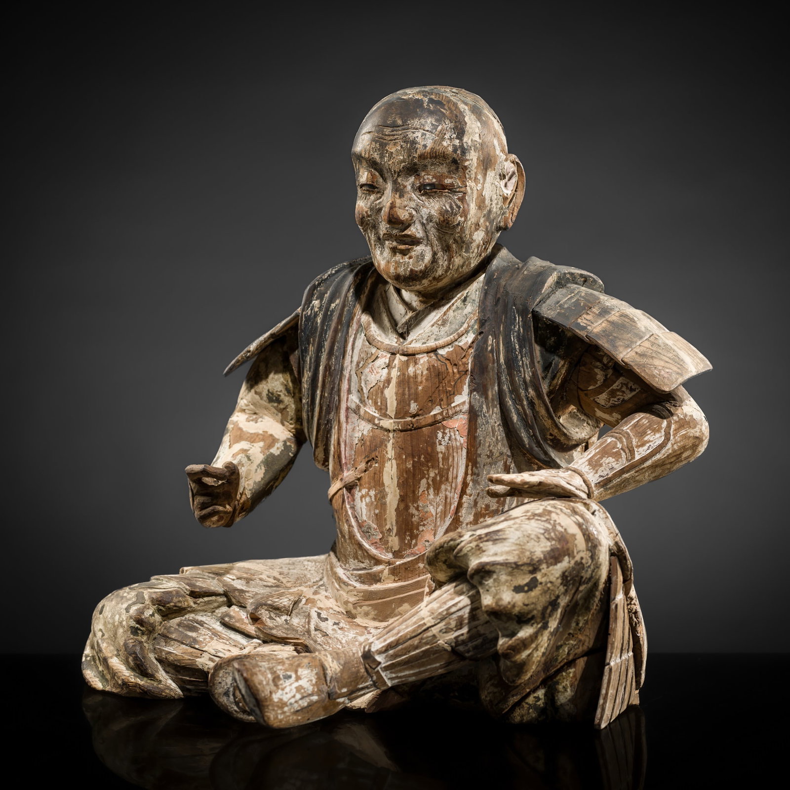 A RARE LARGE POLYCHROME WOOD FIGURE OF A SEATED SAMURAI WARRIOR, EARLY EDO PERIOD: A RARE LARGE POLYCHROME WOOD FIGURE OF A SEATED SAMURAI WARRIOR, EARLY EDO PERIOD Japan, 17th century, early Edo period (1615–1868) The yosegi-zukuri figure finely carved seated, with the left a