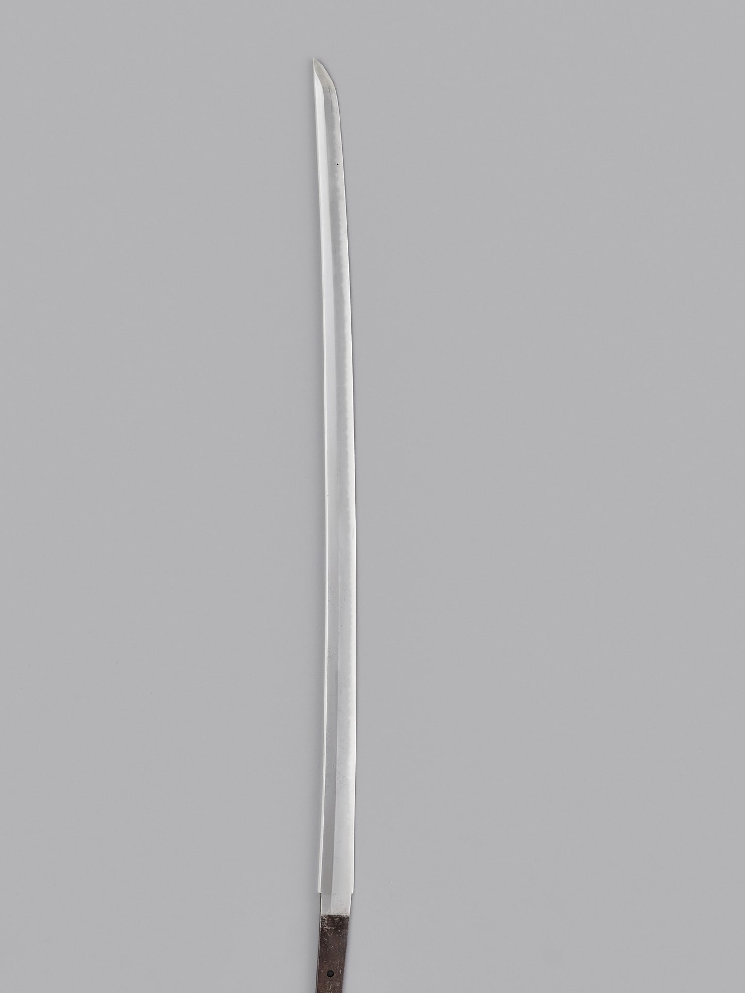 A KATANA IN SHIRASAYA: A KATANA IN SHIRASAYA Japan, 18th century, Edo period (1615-1868) The slender blade with shinogizukuri and iori mune. The hamon with kawazuko-choji, the hada is itame. The nakago (tang) with one mekug