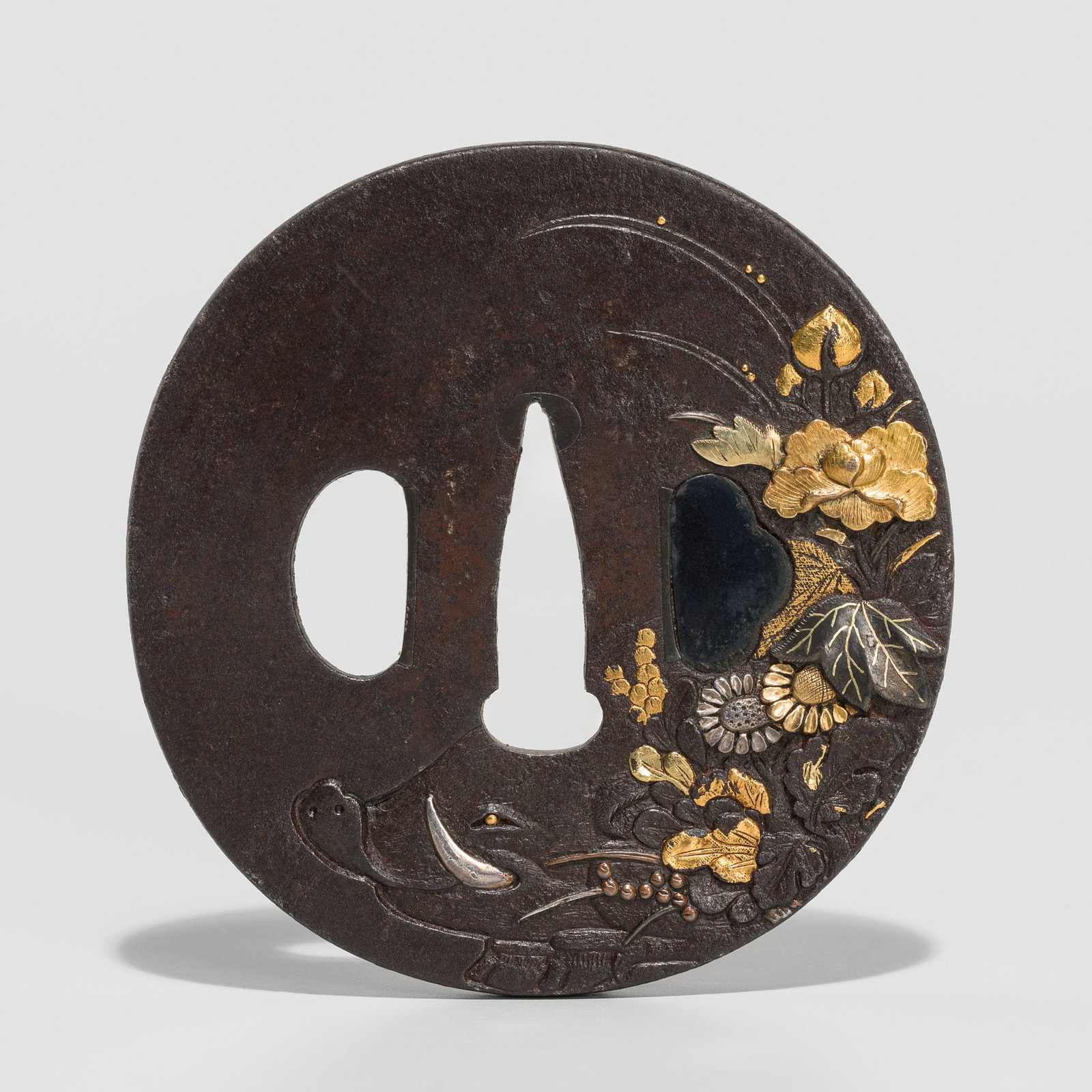 A FINE IRON TSUBA DEPICTING A BOAR AMONGST AUTUMN GRASSES: A FINE IRON TSUBA DEPICTING A BOAR AMONGST AUTUMN GRASSES Unsigned Japan, 18th-19th century, Edo period (1615-1868) Of marugata shape, with a kozuka and kogai hitsu-ana with shakudo ategane, worked in