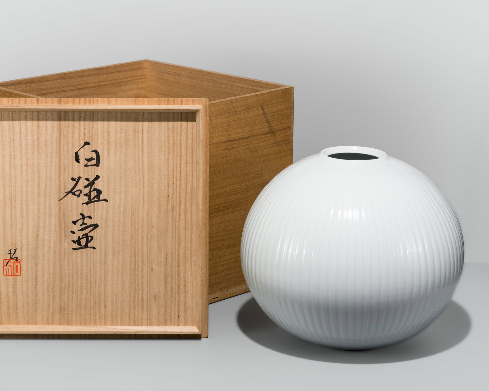NONAKA TAKU: A SUPERB AND IMPOSING CLEAR-GLAZED PORCELAIN FLUTED VASE: NONAKA TAKU: A SUPERB AND IMPOSING CLEAR-GLAZED PORCELAIN FLUTED VASE Nonaka Taku (b.1955), signed by the artist Japan, Heisei period (1989-2019) Brilliantly modeled, the slightly flattened spherical 