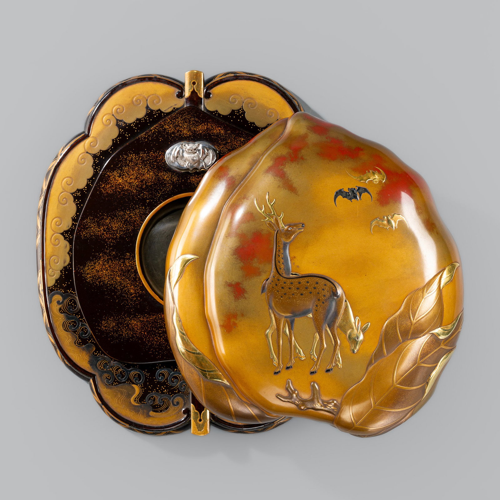 A SUPERB AND UNUSUAL PEACH-SHAPED LACQUER ‘DEER, BATS AND CRANE’ SUZURIBAKO (WRITING: A SUPERB AND UNUSUAL PEACH-SHAPED LACQUER ‘DEER, BATS AND CRANE’ SUZURIBAKO (WRITING BOX) Japan, Meiji period (1868-1912) Of fan-shaped form with a domed, peach-shaped cover, the surface b