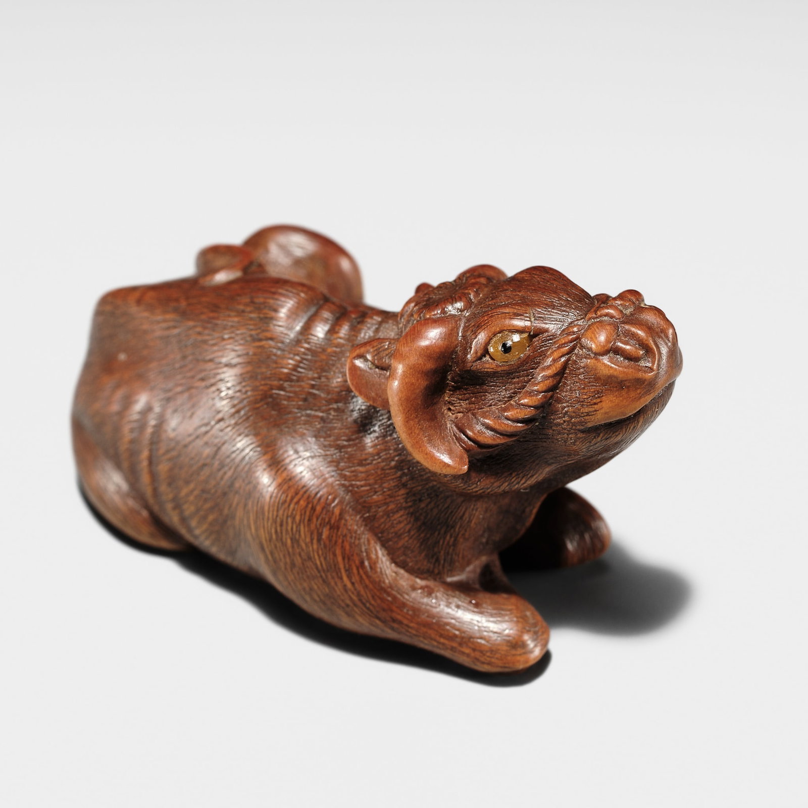 HARUMITSU: A SUPERB WOOD NETSUKE OF A RECUMBENT OX (1 of 15)
