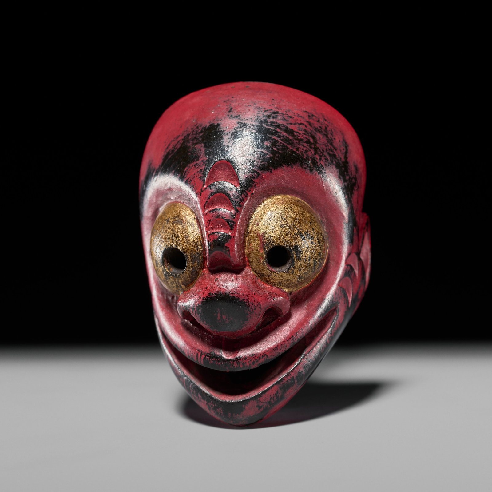GYOKUZAN: A RARE AND UNUSUAL YOKAI MASK NETSUKE: GYOKUZAN: A RARE AND UNUSUAL YOKAI MASK NETSUKE By Gyokuzan, signed Gyokuzan Japan, Tokyo, Meiji period (1868-1912) Boldly carved as a humorous yokai mask with exaggerated features, the face lacquered
