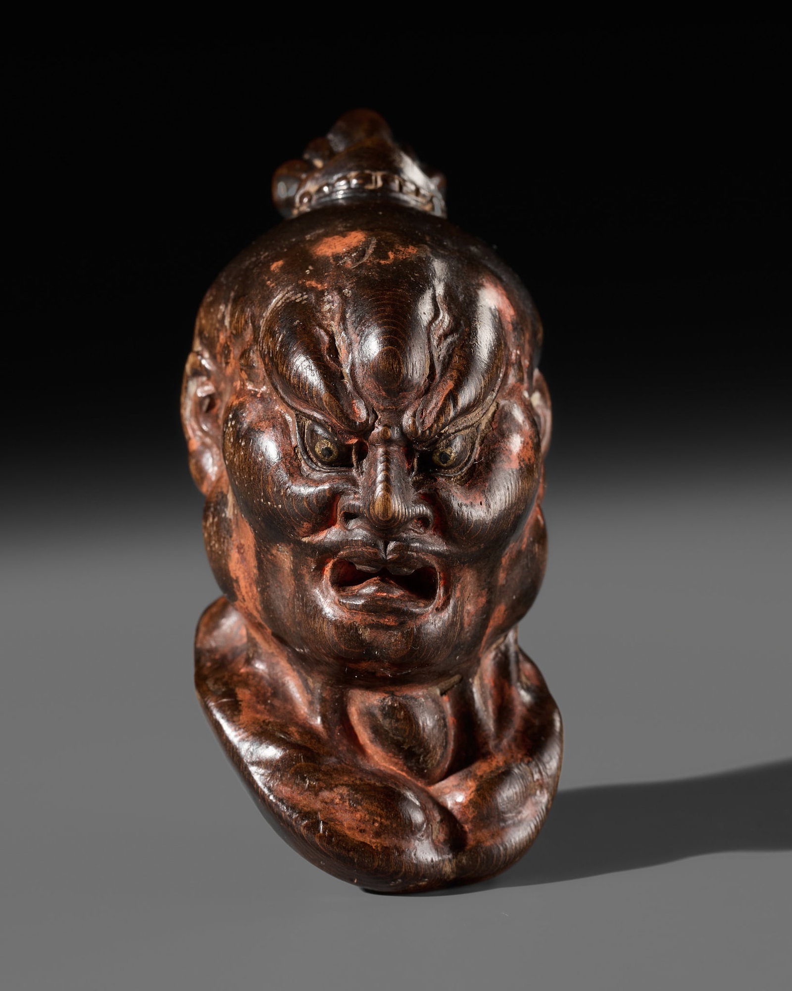A LARGE AND SUPERB LACQUERED AND CARVED HINOKI WOOD NETSUKE OF A NIO HEAD, ATTRIBUTED TO NAITO: A LARGE AND SUPERB LACQUERED AND CARVED HINOKI WOOD NETSUKE OF A NIO HEAD, ATTRIBUTED TO NAITO KOSEKI Attributed to Naito Koseki (1871-1948), unsigned Japan, Kyoto, c. 1900-1930 Masterfully carved in 