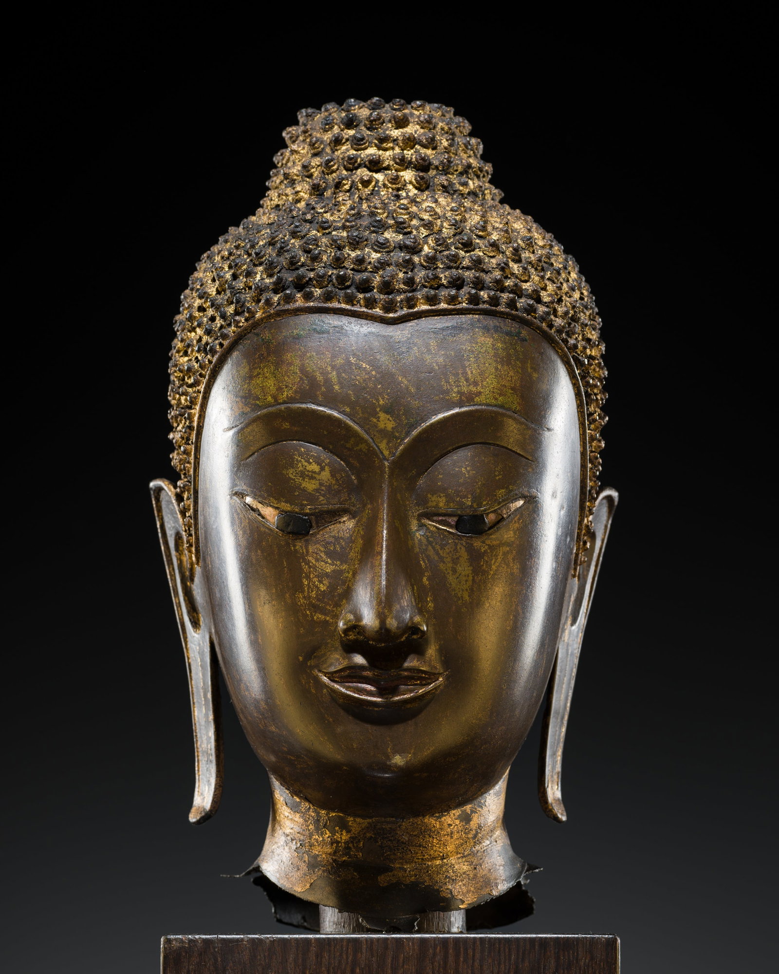A GILT-LACQUERED BRONZE HEAD OF BUDDHA SHAKYAMUNI, AYUTTHAYA PERIOD, 15TH-16TH CENTURY: A GILT-LACQUERED BRONZE HEAD OF BUDDHA SHAKYAMUNI, AYUTTHAYA PERIOD, 15TH-16TH CENTURY This lot is from a single owner collection and is therefore offered without reserve The Jorgen Ruben Gallery Ledg