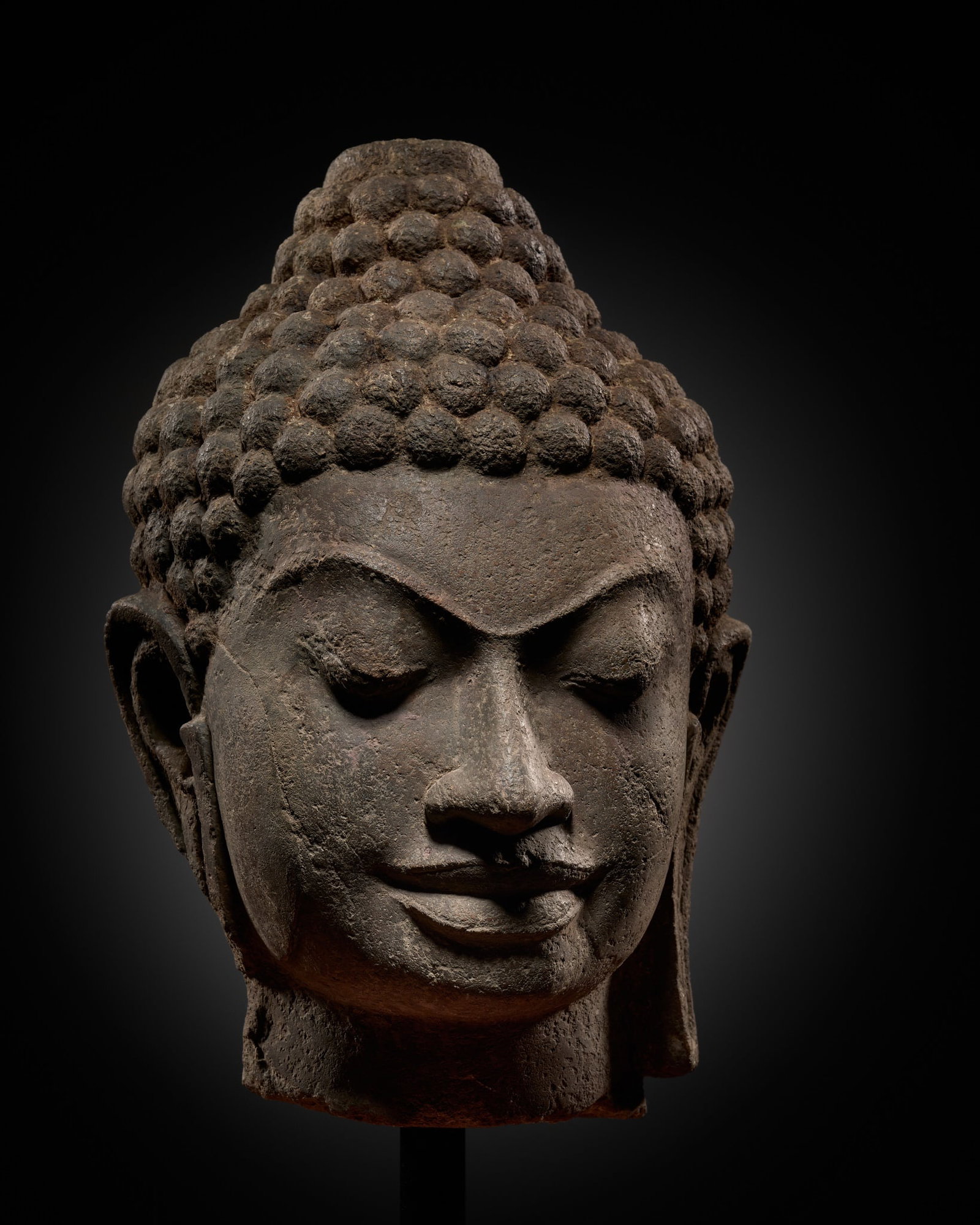 A RARE AND LARGE LIMESTONE HEAD OF BUDDHA, MON-DVARAVATI PERIOD: A RARE AND LARGE LIMESTONE HEAD OF BUDDHA, MON-DVARAVATI PERIOD This lot is from a single owner collection and is therefore offered without reserve Expert's note: This magnificent head is a very larg
