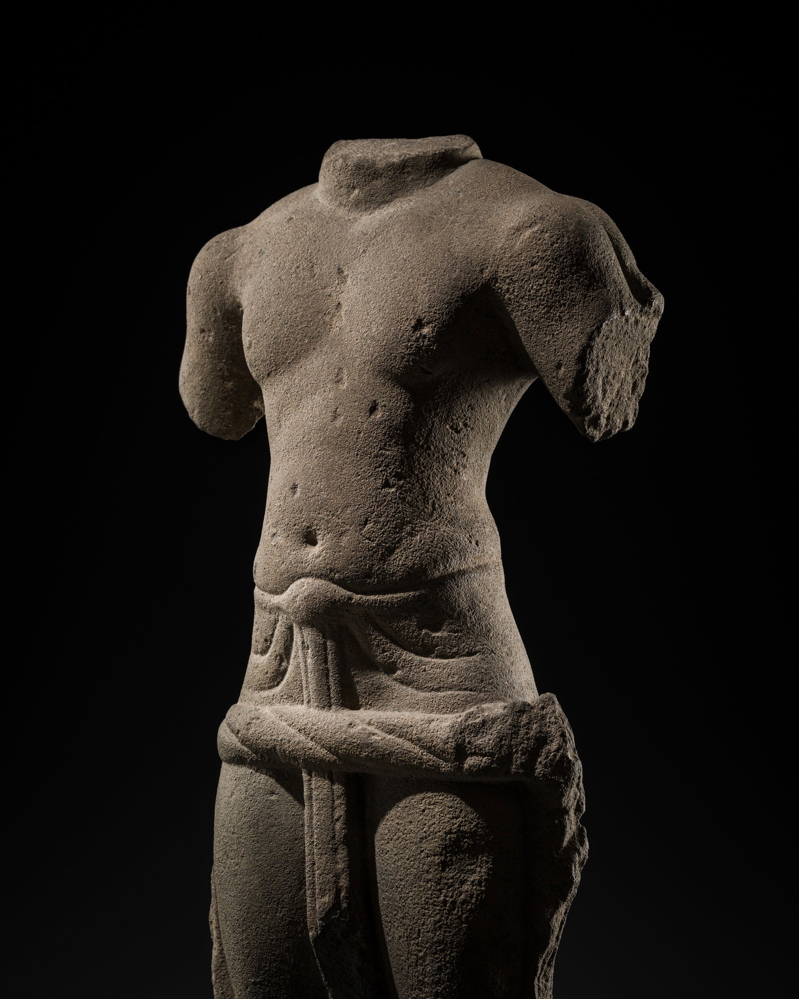 A FINE SANDSTONE TORSO OF A MALE DEITY, PRASAT ANDET STYLE, PRE-ANGKORIAN PERIOD, 7TH CENTURY: A FINE SANDSTONE TORSO OF A MALE DEITY, PRASAT ANDET STYLE, PRE-ANGKORIAN PERIOD, 7TH CENTURY This lot is from a single owner collection and is therefore offered without reserve The Jorgen Ruben Galle