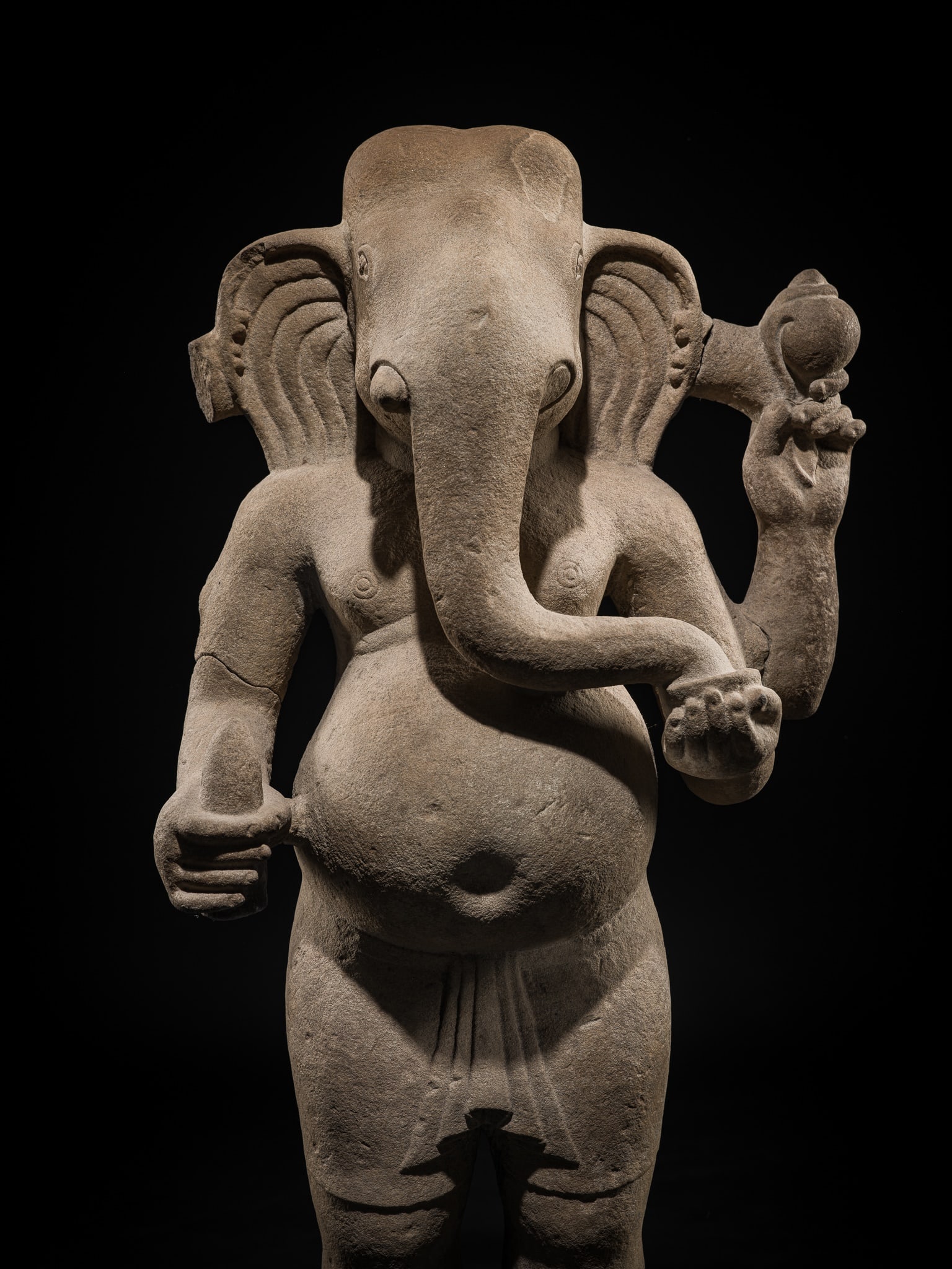 A RARE AND LARGE SANDSTONE FIGURE OF GANESHA, PRASAT ANDET STYLE, PRE-ANGKOR PERIOD, 7TH CENTURY (1 of 17)