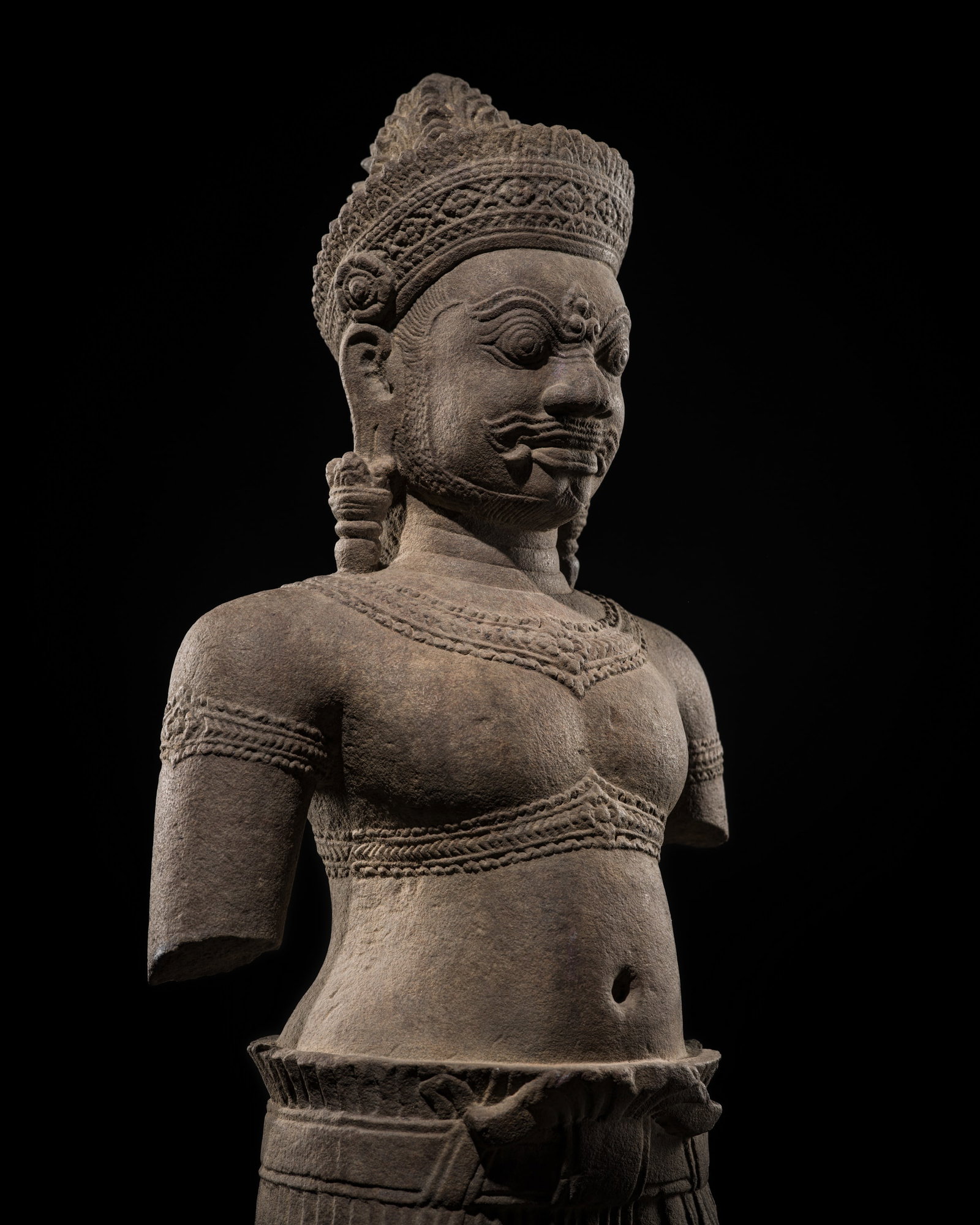 A SANDSTONE GUARDIAN FIGURE OF A YAKSHA, BAKHENG STYLE, ANGKOR PERIOD, 10TH CENTURY: A SANDSTONE GUARDIAN FIGURE OF A YAKSHA, BAKHENG STYLE, ANGKOR PERIOD, 10TH CENTURY This lot is from a single owner collection and is therefore offered without reserve The Jorgen Ruben Gallery Ledger,