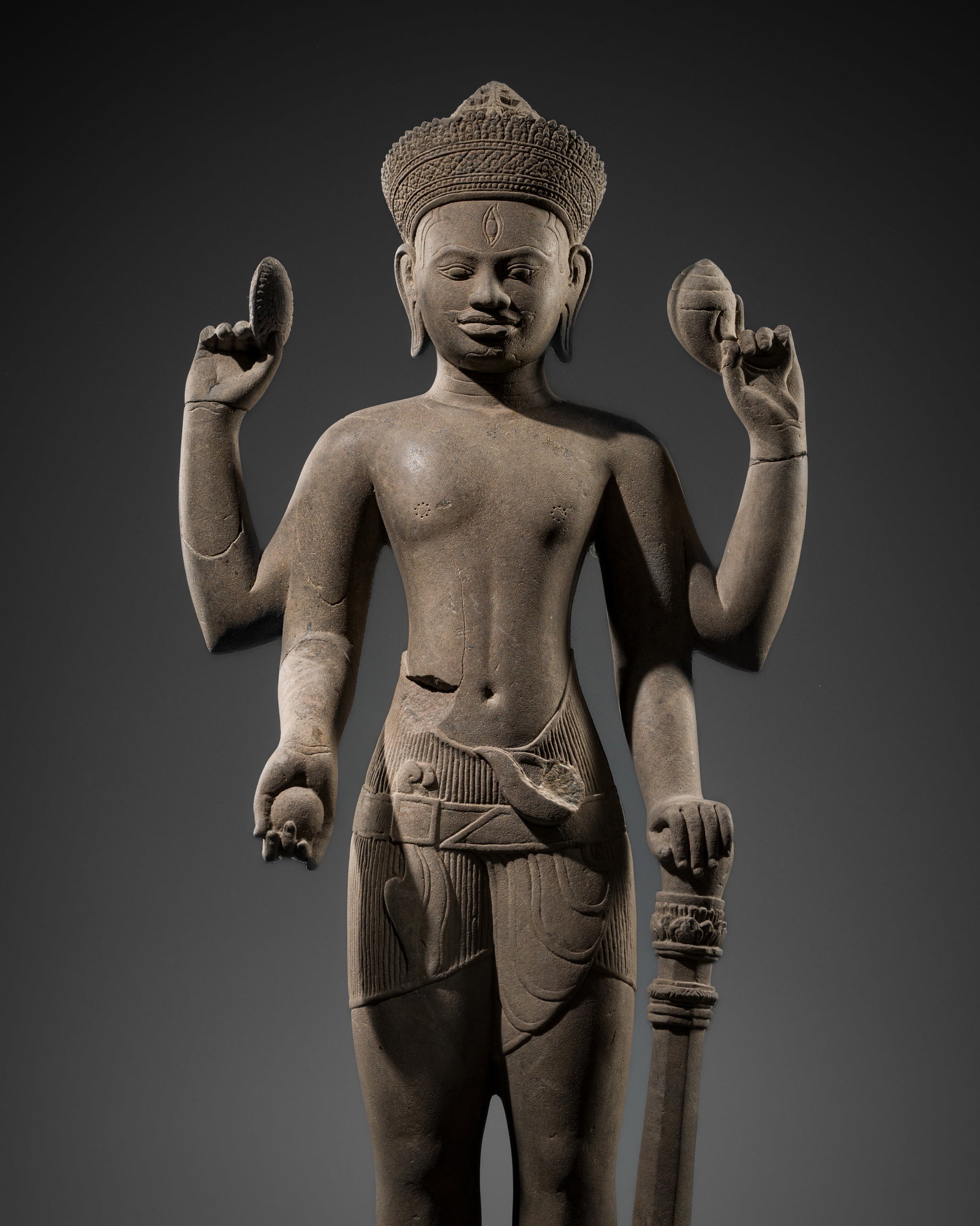 A RARE AND IMPORTANT SANDSTONE FIGURE OF VISHNU, BAPHUON STYLE, ANGKOR PERIOD, 11TH CENTURY: A RARE AND IMPORTANT SANDSTONE FIGURE OF VISHNU, BAPHUON STYLE, ANGKOR PERIOD, 11TH CENTURY This lot is from a single owner collection and is therefore offered without reserve Khmer Empire, Cambodia. 
