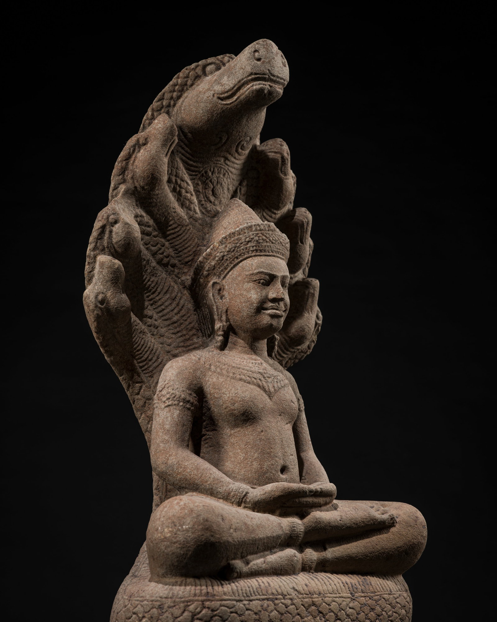 A SANDSTONE FIGURE OF BUDDHA MUCHALINDA, ANGKOR WAT STYLE, 12TH CENTURY: A SANDSTONE FIGURE OF BUDDHA MUCHALINDA, ANGKOR WAT STYLE, 12TH CENTURY This lot is from a single owner collection and is therefore offered without reserve The Jorgen Ruben Gallery Ledger, entry from 