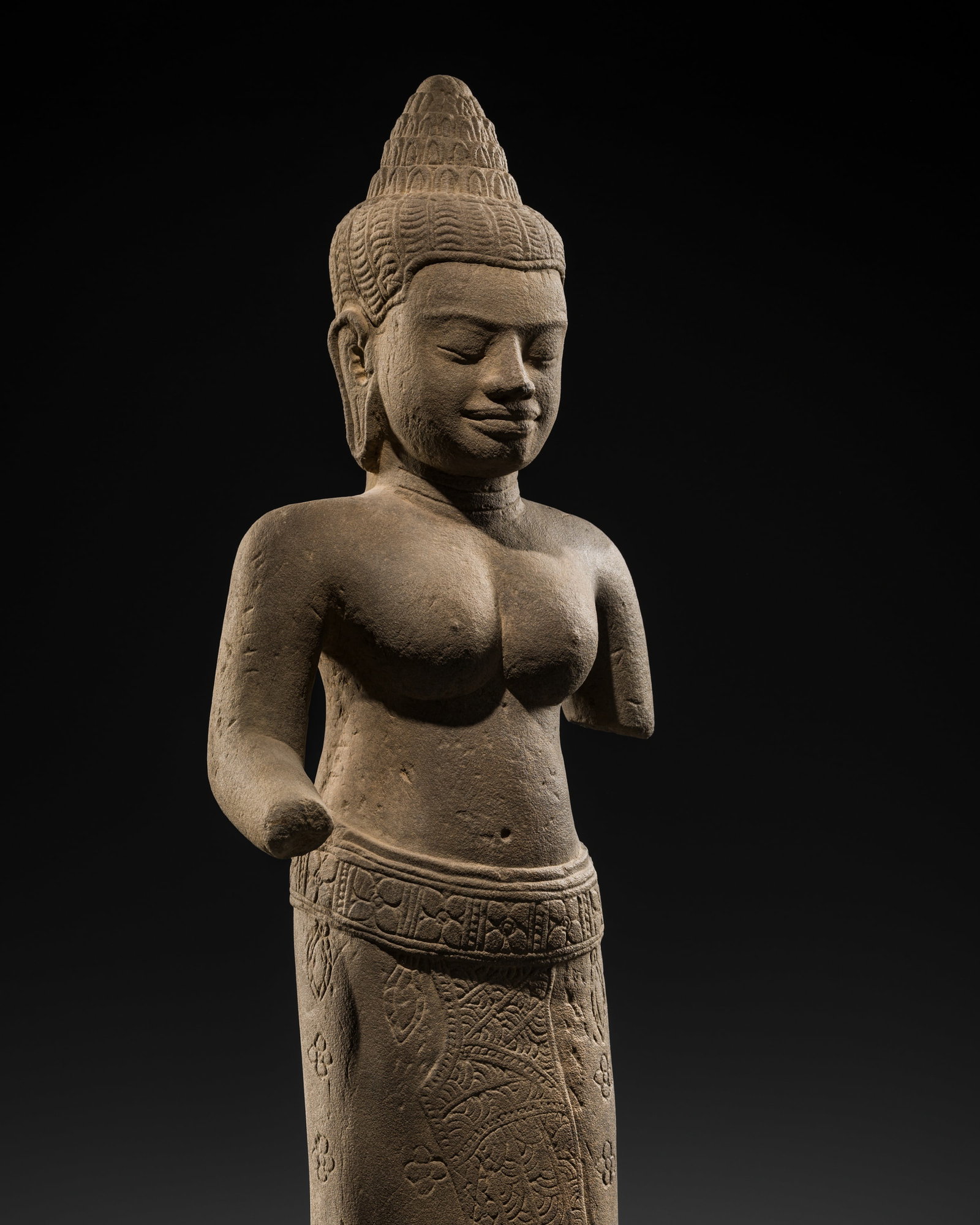 A SANDSTONE FIGURE OF UMA, BAYON STYLE, ANGKOR PERIOD, 13TH CENTURY: A SANDSTONE FIGURE OF UMA, BAYON STYLE, ANGKOR PERIOD, 13TH CENTURY This lot is from a single owner collection and is therefore offered without reserve The Jorgen Ruben Gallery Ledger, entry from 2005