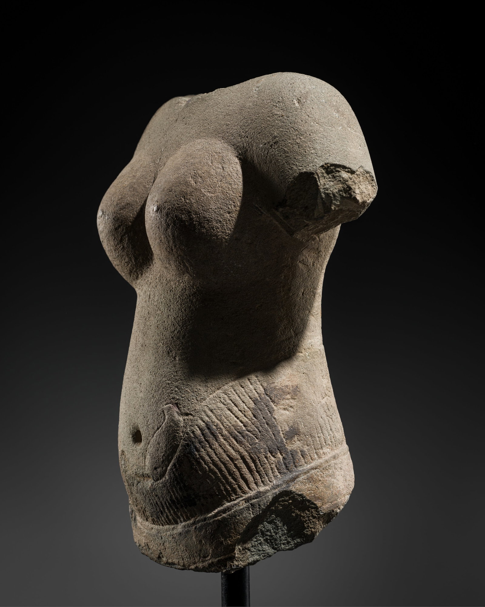 A KHMER SANDSTONE TORSO OF UMA, ANGKOR PERIOD, BAPHUON STYLE, 11TH CENTURY: A KHMER SANDSTONE TORSO OF UMA, ANGKOR PERIOD, BAPHUON STYLE, 11TH CENTURY This lot is from a single owner collection and is therefore offered without reserve Finely carved and sensuously modeled, her