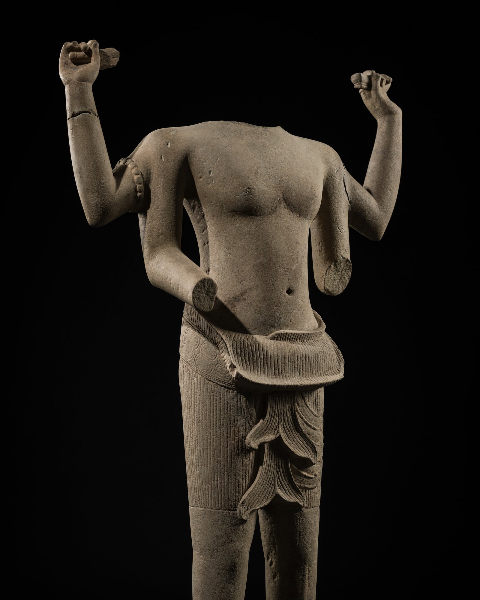A LARGE SANDSTONE FIGURE OF VISHNU, ANGKOR PERIOD, ANGKOR WAT STYLE, 12TH CENTURY: A LARGE SANDSTONE FIGURE OF VISHNU, ANGKOR PERIOD, ANGKOR WAT STYLE, 12TH CENTURY This lot is from a single owner collection and is therefore offered without reserve The Jorgen Ruben Gallery Ledger, e
