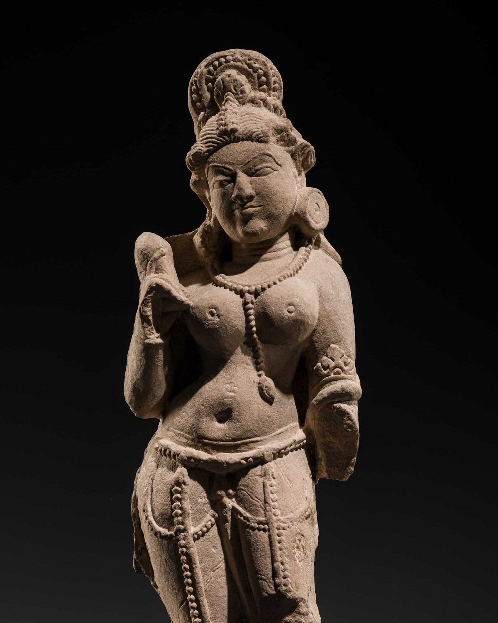 A RED SANDSTONE FIGURE OF A CELESTIAL BEAUTY, SURASUNDARI, MADHYA PRADESH, 12TH CENTURY: A RED SANDSTONE FIGURE OF A CELESTIAL BEAUTY, SURASUNDARI, MADHYA PRADESH, 12TH CENTURY This lot is from a single owner collection and is therefore offered without reserve The Jorgen Ruben Gallery Led