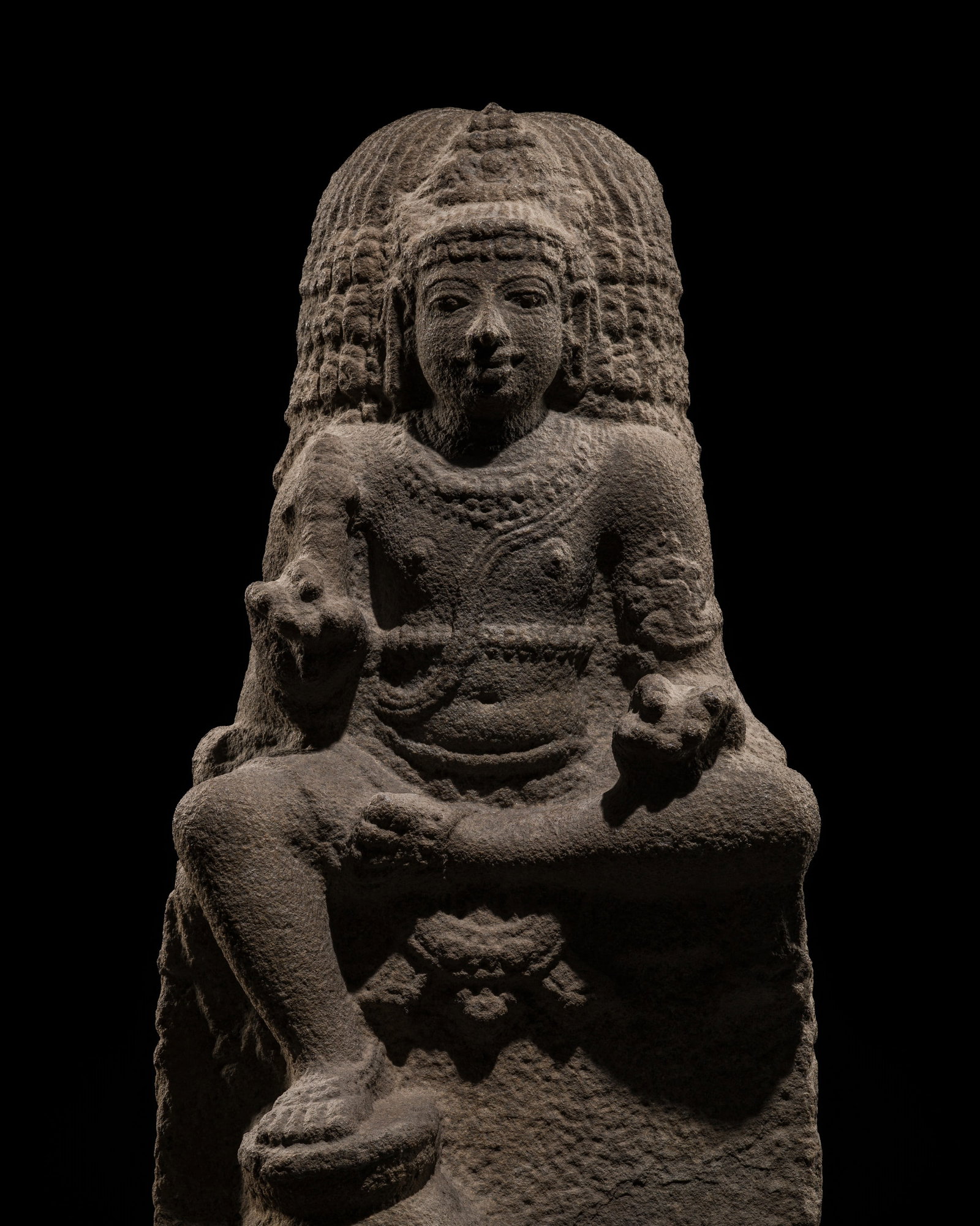 A RARE GRANITE FIGURE OF CHANDIKESHVARA, CHOLA DYNASTY, 13TH CENTURY: A RARE GRANITE FIGURE OF CHANDIKESHVARA, CHOLA DYNASTY, 13TH CENTURY This lot is from a single owner collection and is therefore offered without reserve South India, Tamil Nadu. The saint is shown sea