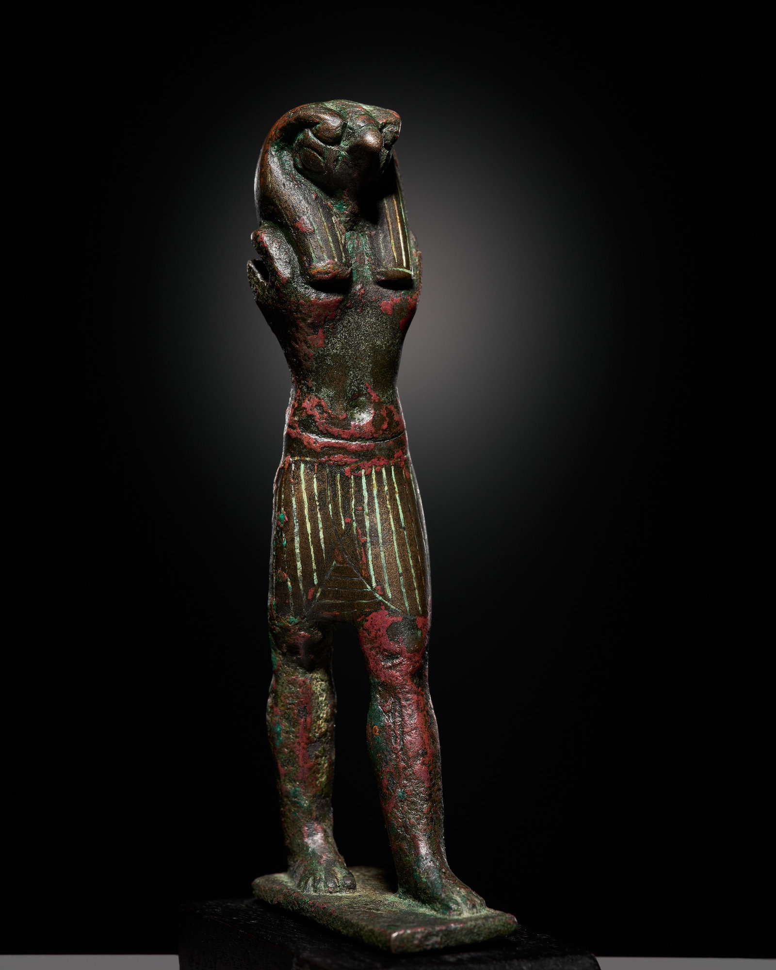 AN EGYPTIAN BRONZE FIGURE OF A FALCON-HEADED HORUS, THIRD INTERMEDIATE-LATE PERIOD (1 of 16)