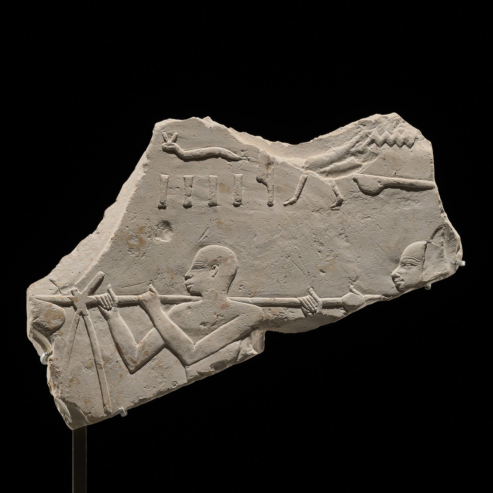 AN EGYPTIAN PLASTER RELIEF FRAGMENT WITH MALE PORTERS, LATE PERIOD, DYNASTY XXVI: AN EGYPTIAN PLASTER RELIEF FRAGMENT WITH MALE PORTERS, LATE PERIOD, DYNASTY XXVI This lot is from a single owner collection and is therefore offered without reserve The Jorgen Ruben Gallery Ledger, en