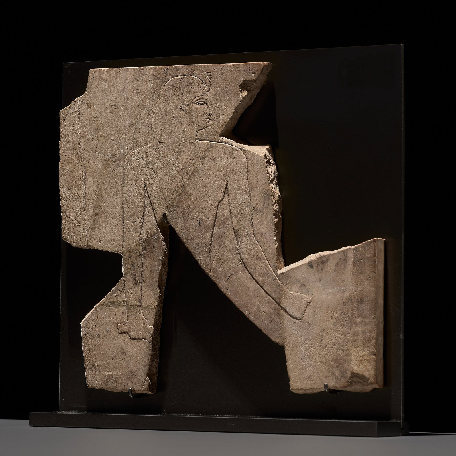 AN EGYPTIAN LIMESTONE SCULPTOR'S MODEL RELIEF FRAGMENT DEPICTING A PHARAOH, PTOLEMAIC PERIOD: AN EGYPTIAN LIMESTONE SCULPTOR'S MODEL RELIEF FRAGMENT DEPICTING A PHARAOH, PTOLEMAIC PERIOD This lot is from a single owner collection and is therefore offered without reserve The Jorgen Ruben Galler