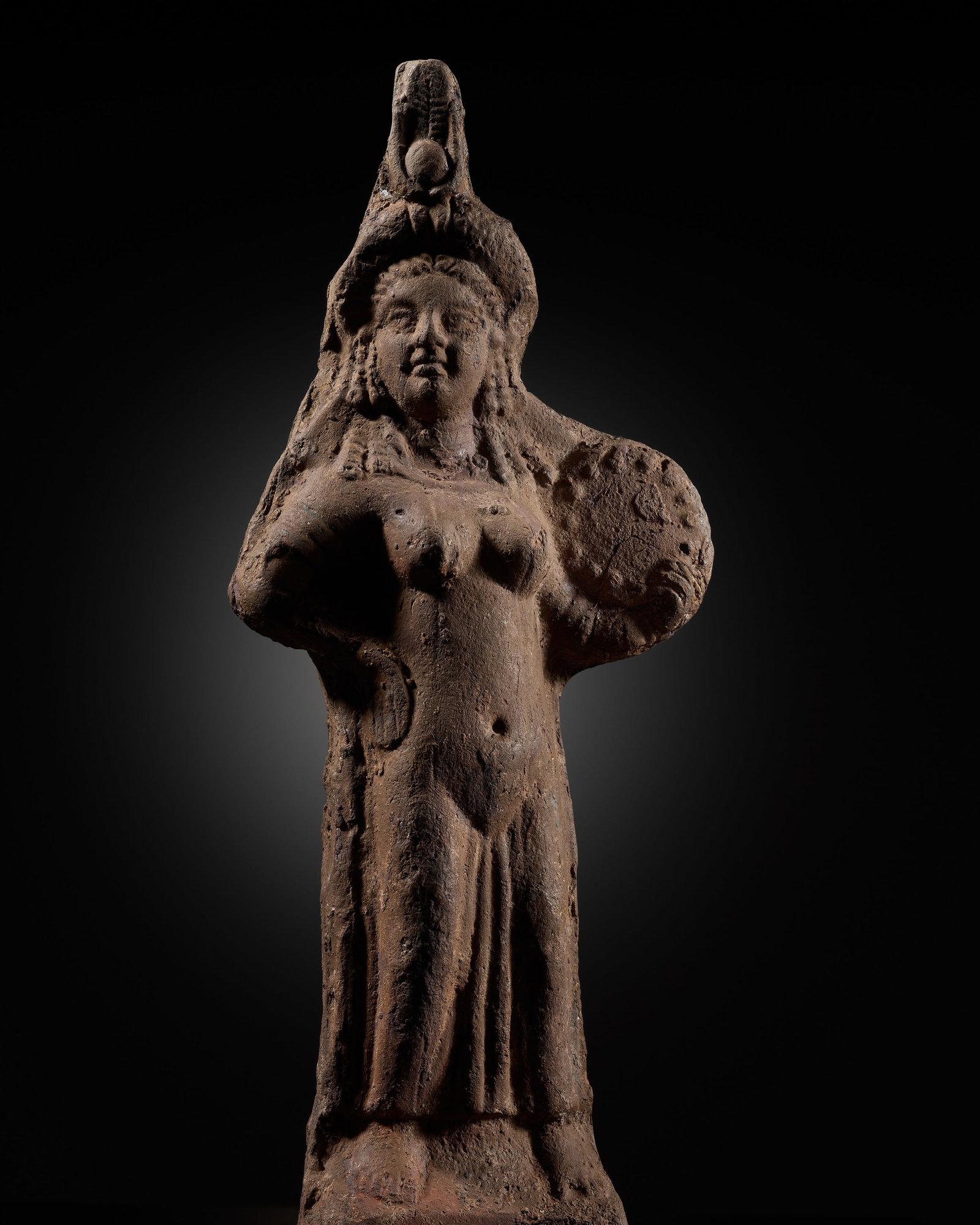 A FINE EGYPTIAN TERRACOTTA FIGURE OF ISIS WITH TYMPANON, ROMAN PERIOD: A FINE EGYPTIAN TERRACOTTA FIGURE OF ISIS WITH TYMPANON, ROMAN PERIOD This lot is from a single owner collection and is therefore offered without reserve The Jorgen Ruben Gallery Ledger, entry from 20